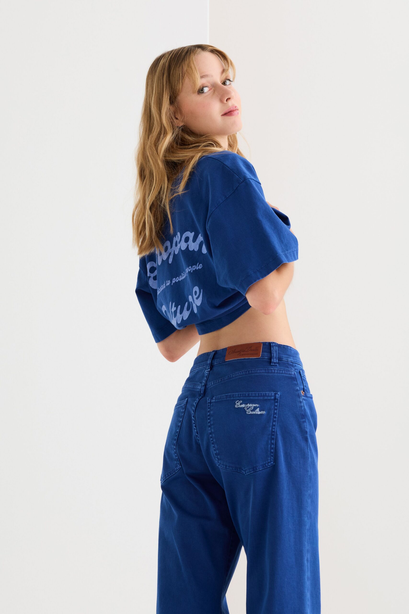 blue cropped shirt and denim pants
