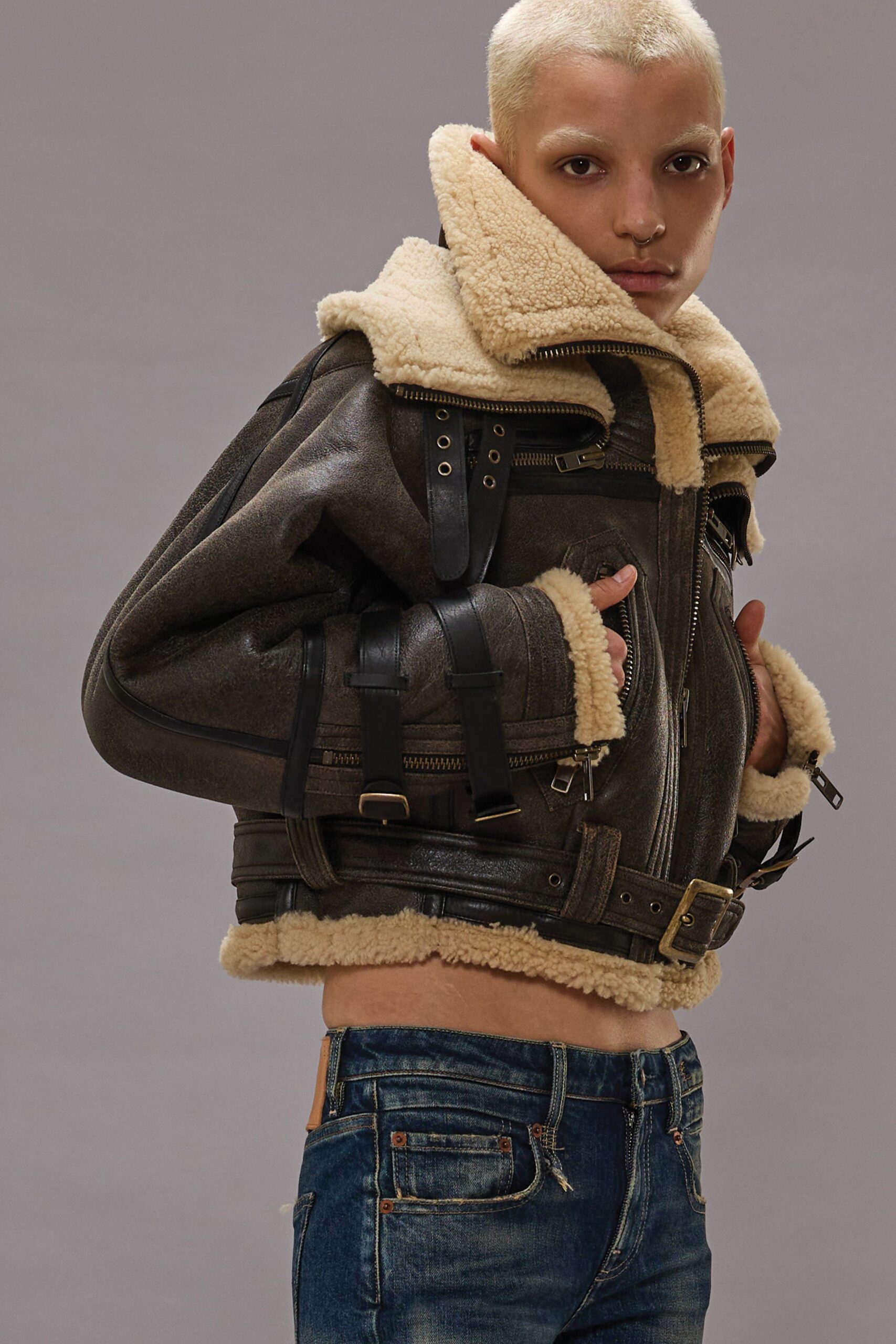 oversized brown leather jacket with blue jeans