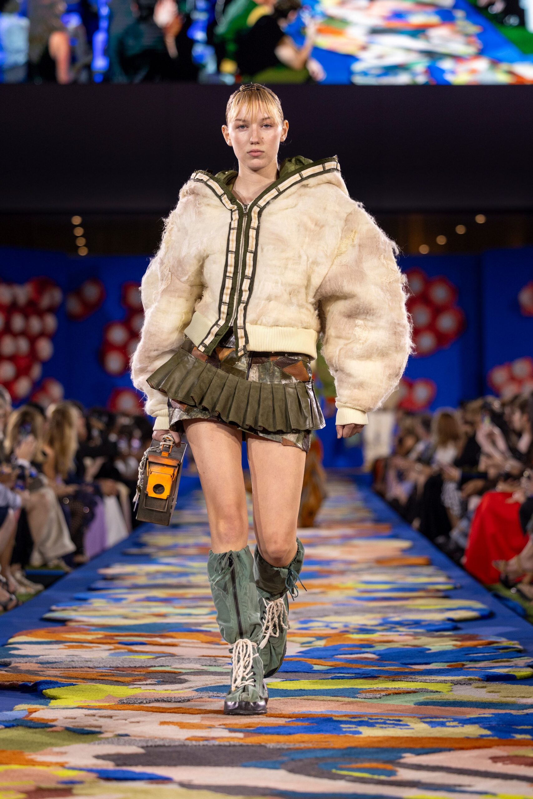 oversized white faux-fur jacket with mini green skirt