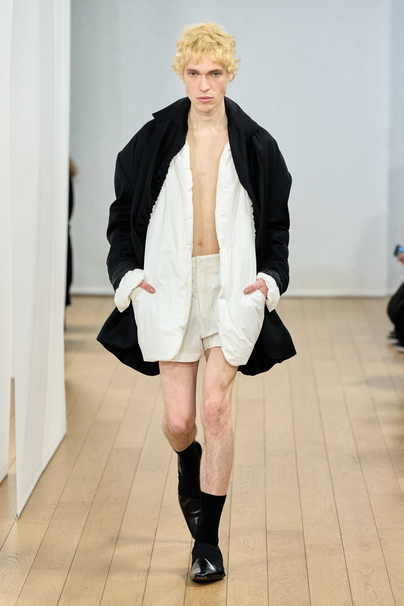 black coat white shirt shorts