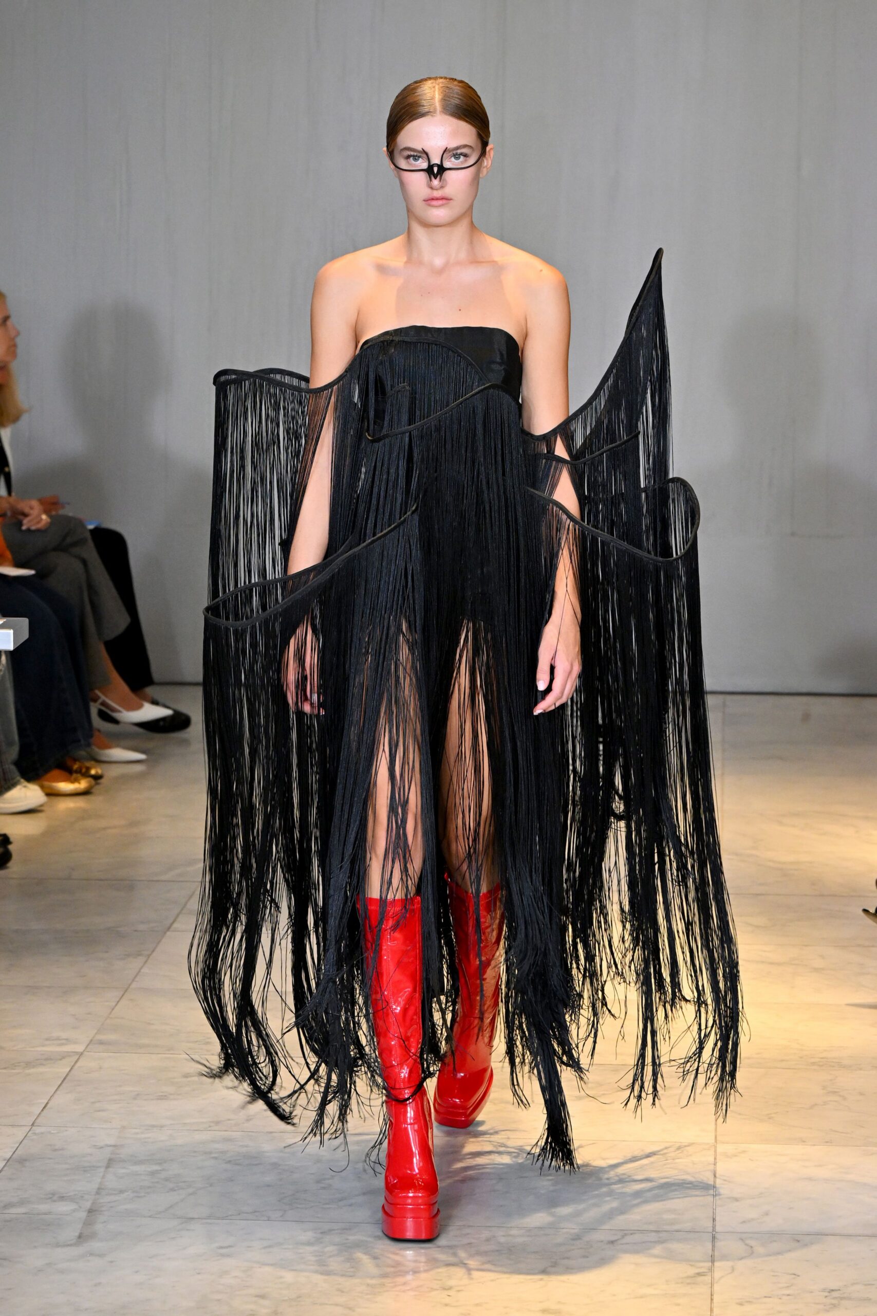 black fringed mini dress with red boots