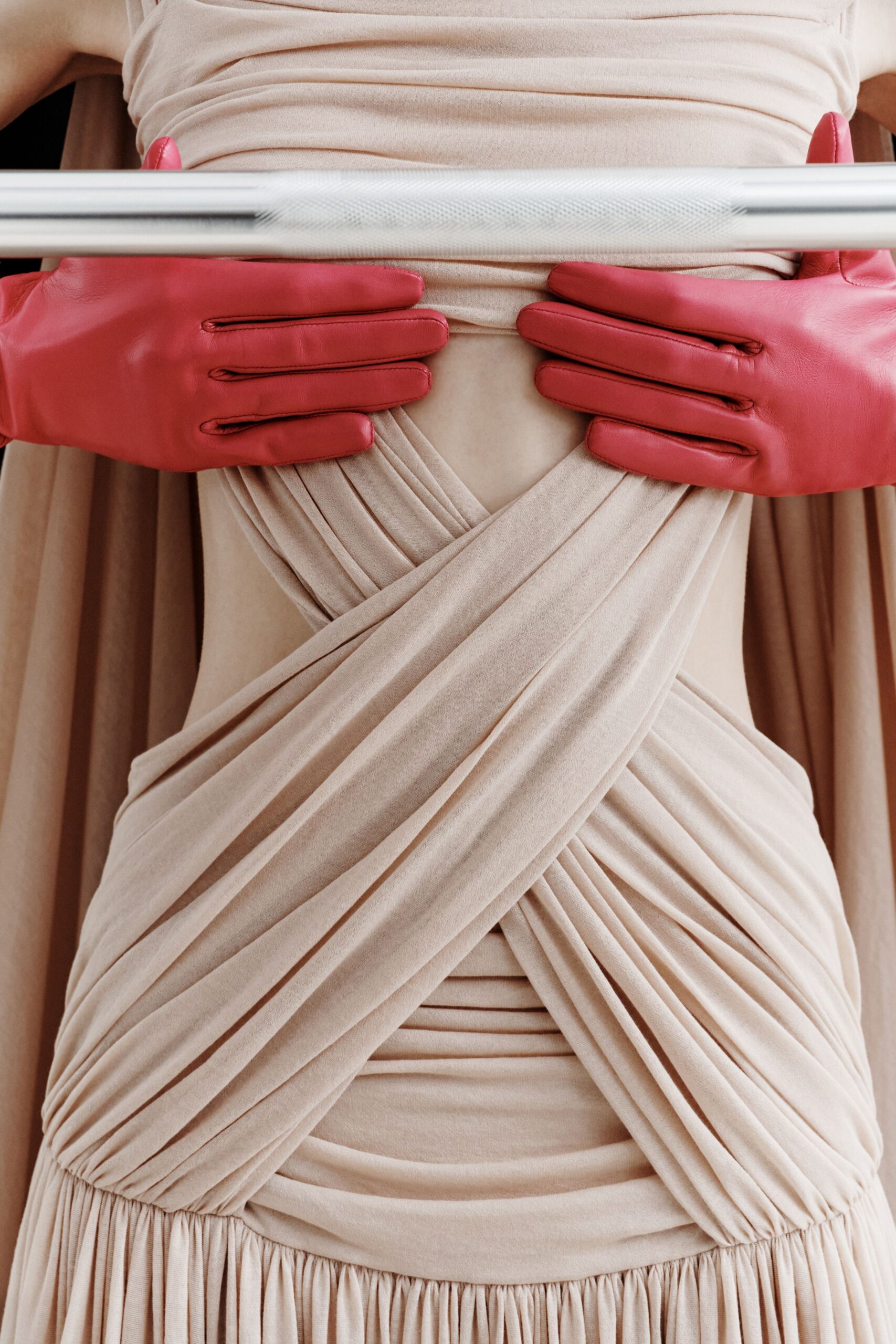 beige silk fitted gown with red gloves