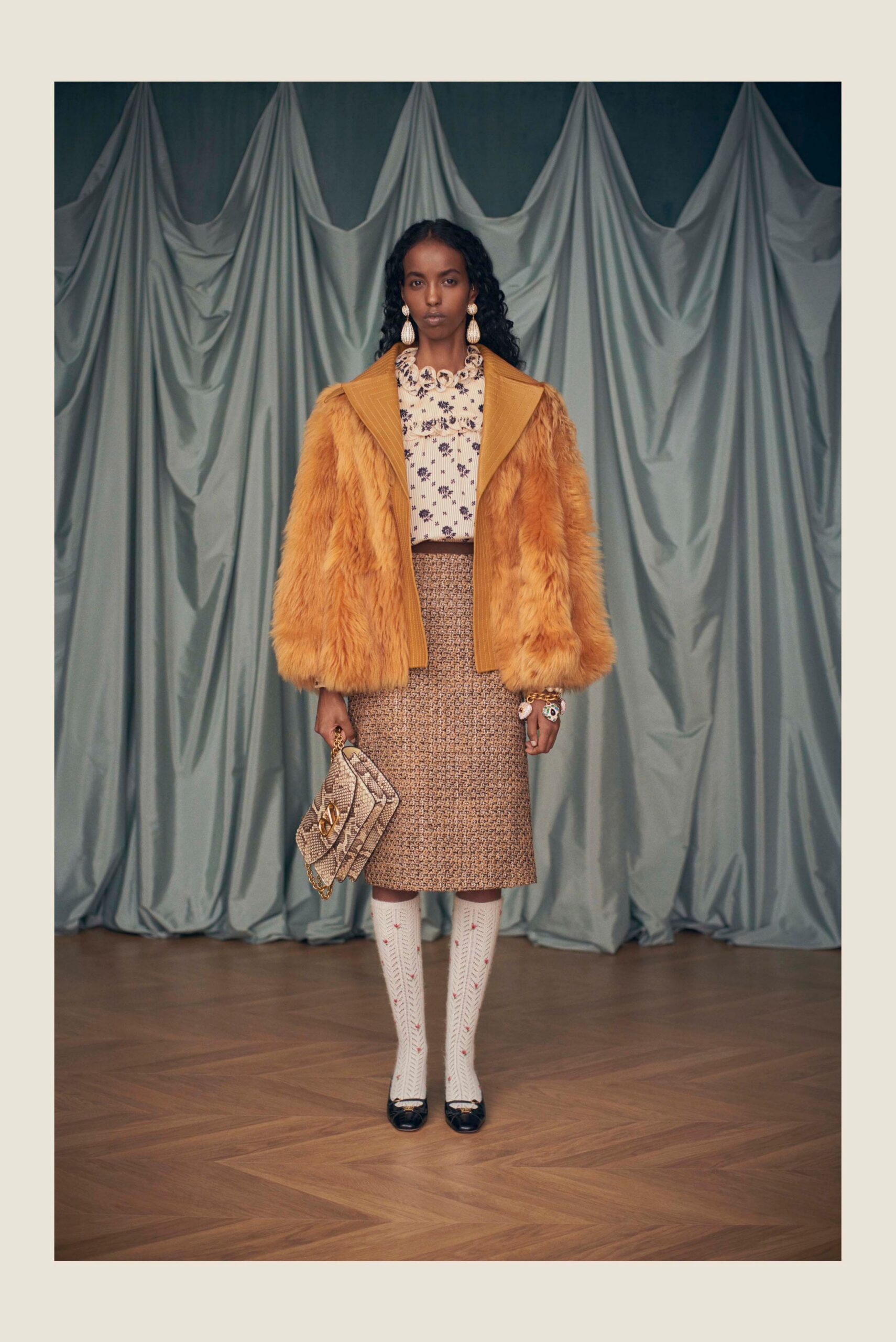 orange faux-fur coat with floral blouse