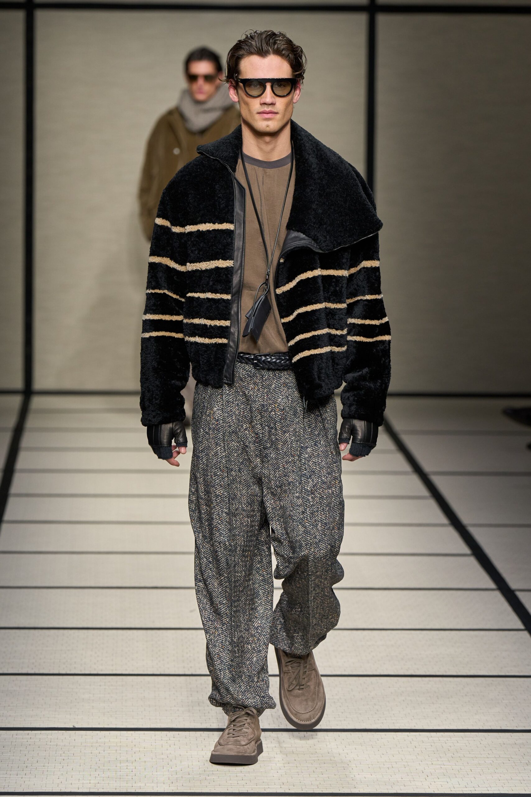 black faux-fur jacket with gray pants