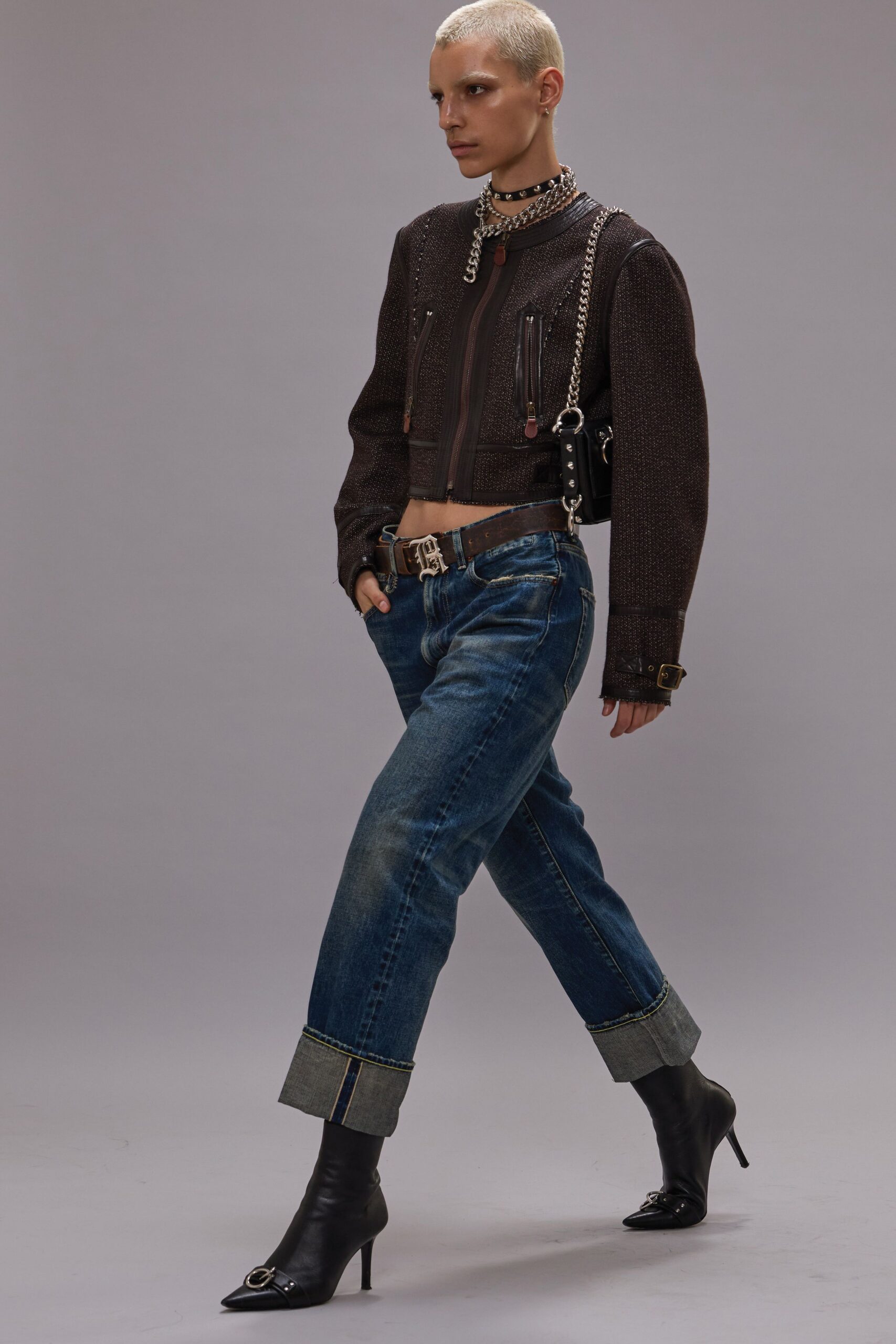 black fitted jacket with blue jeans and boots