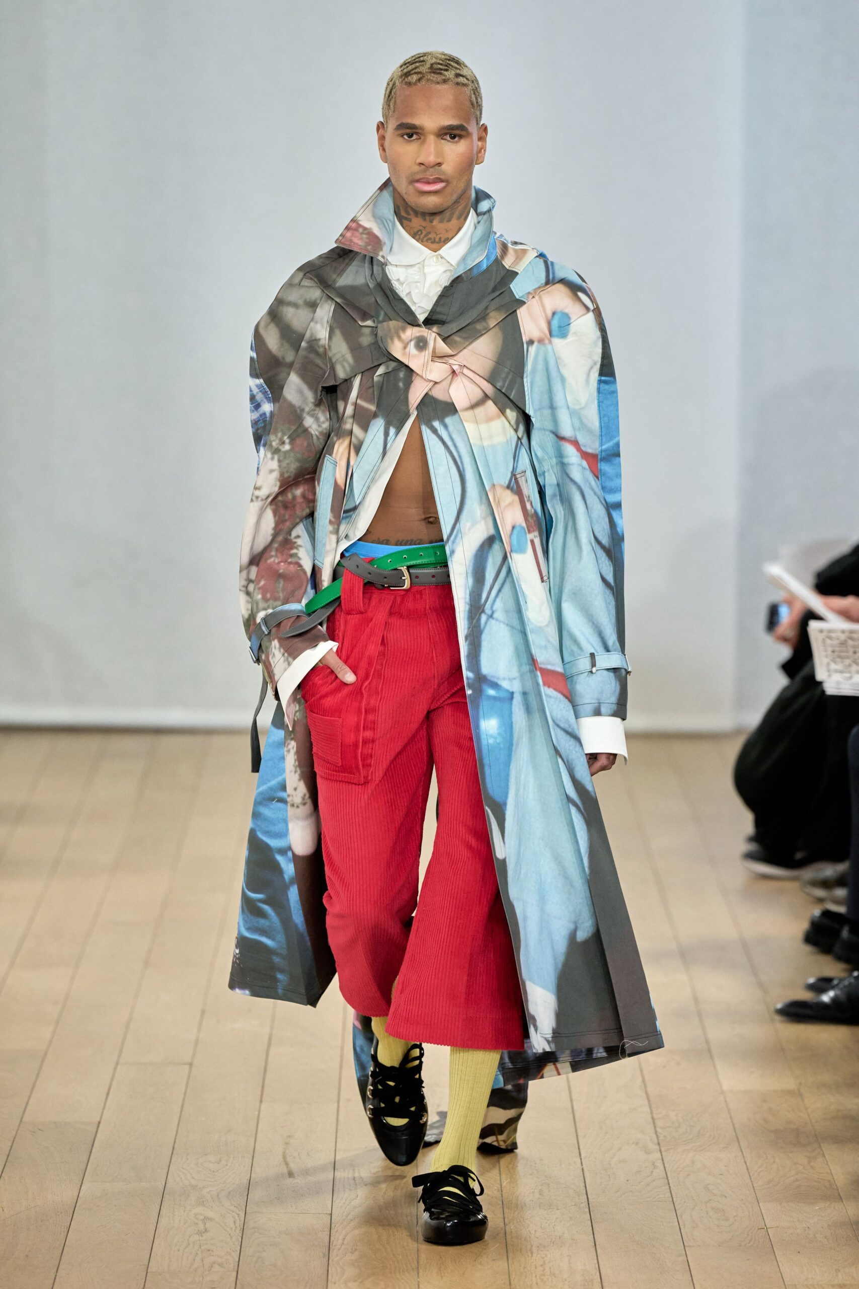 multi printed coat with red pants