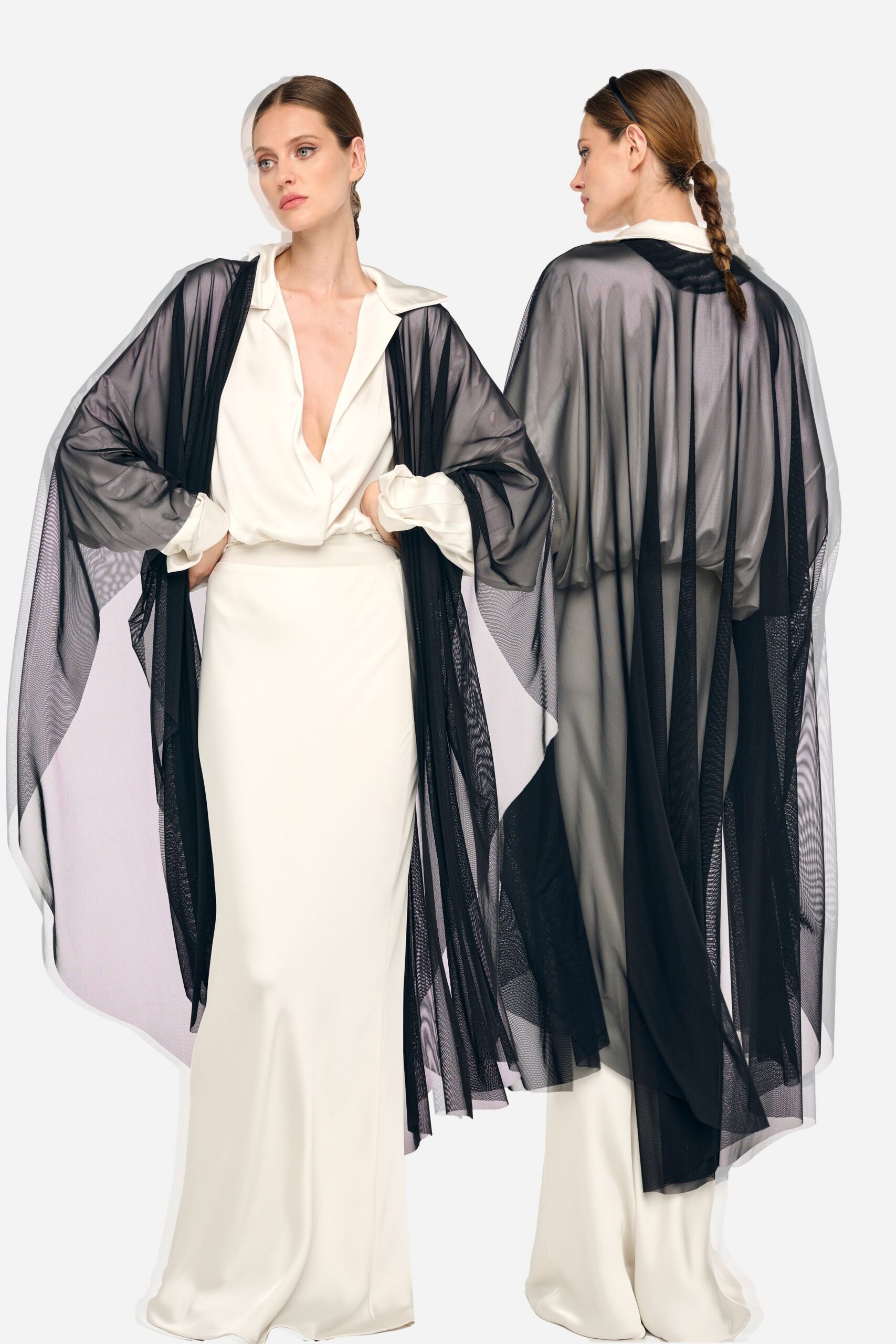 white silk fitted gown with black cape