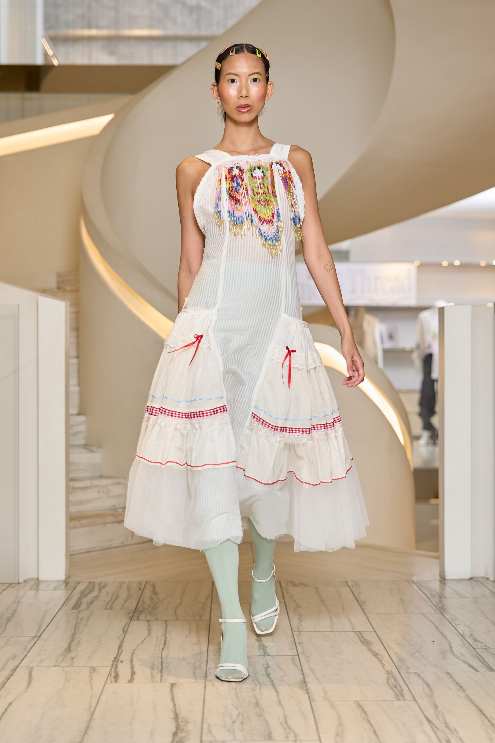 white pleated midi dress with open-toe shoes
