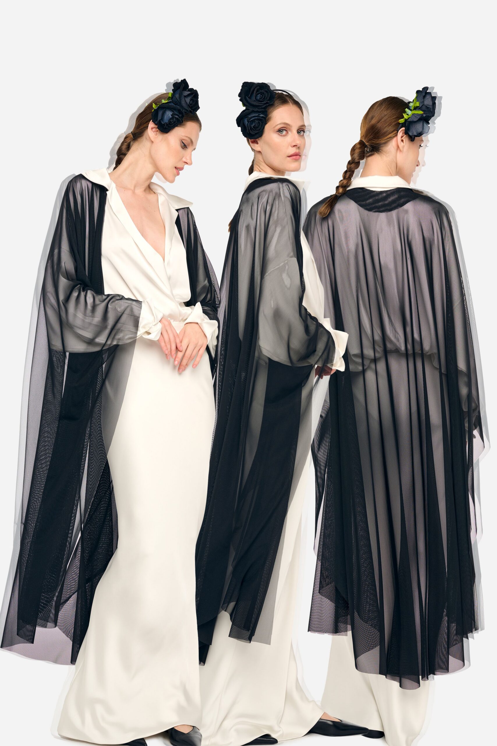 white silk fitted gown with black cape