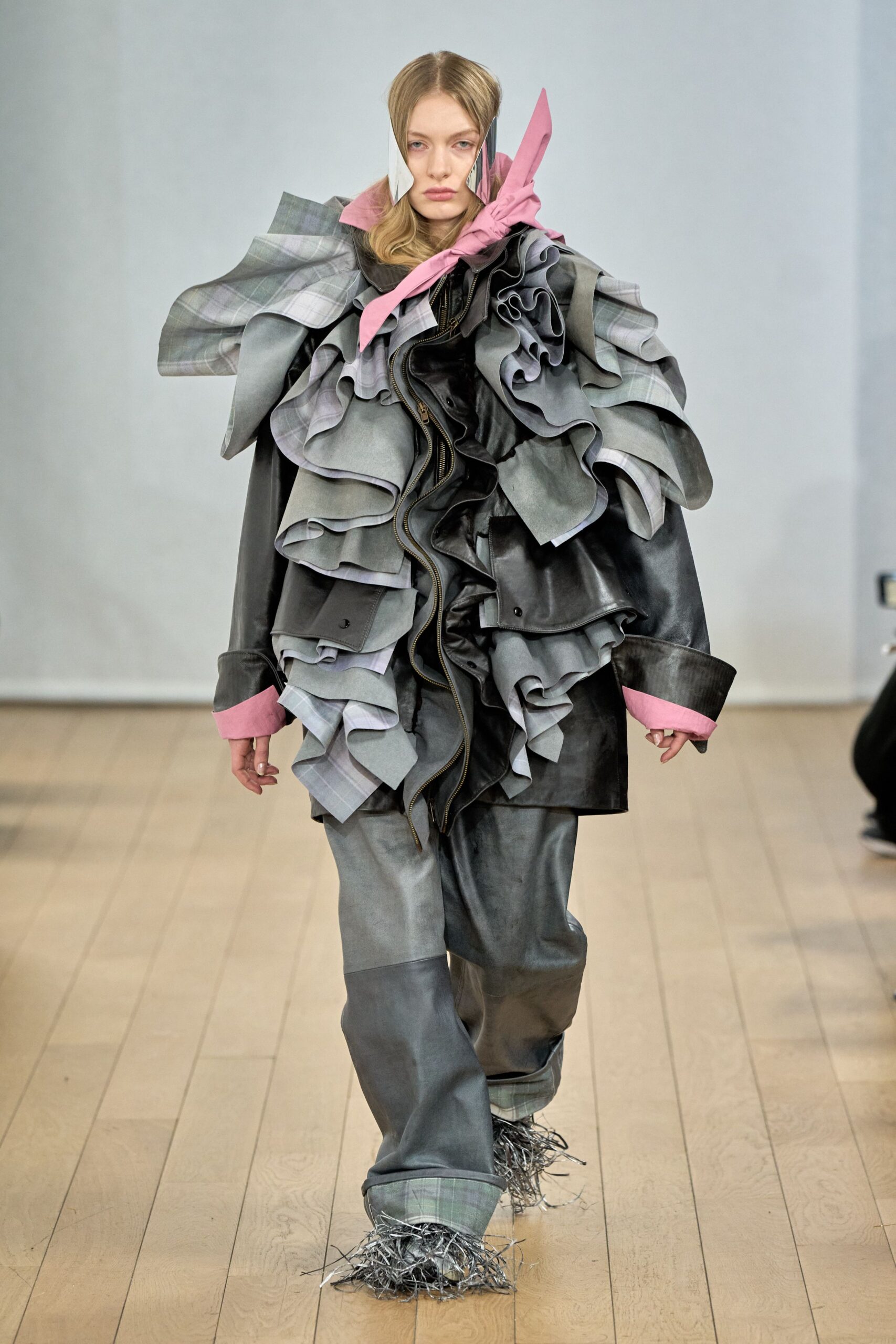 black and gray ruffled jacket with pink scarf