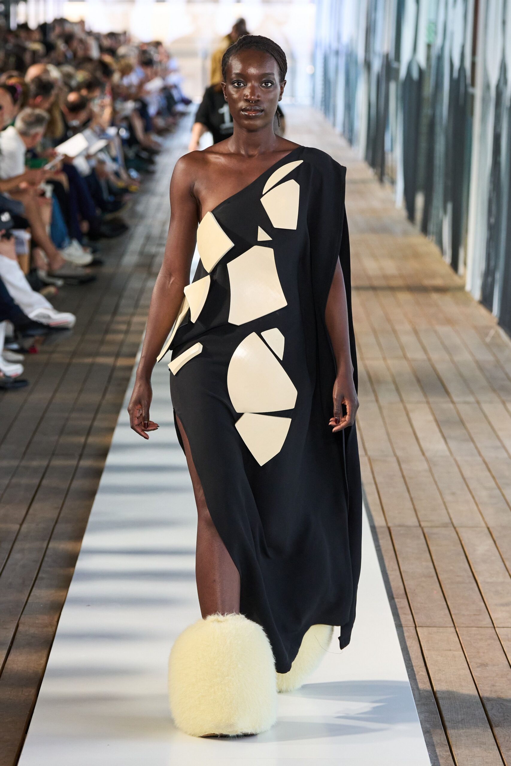 black asymmetric gown with fur shoes