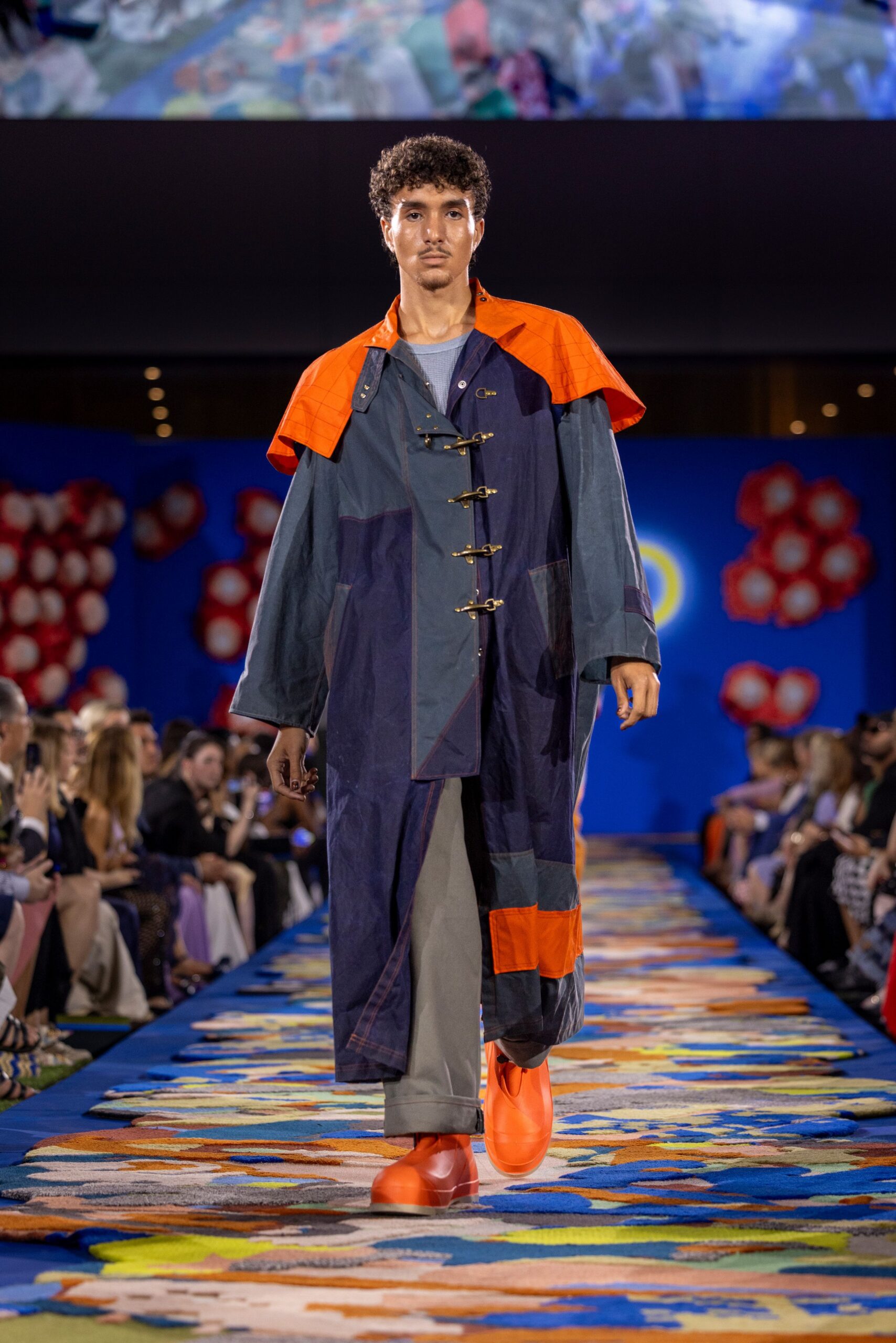 blue and orange coat with gray pants