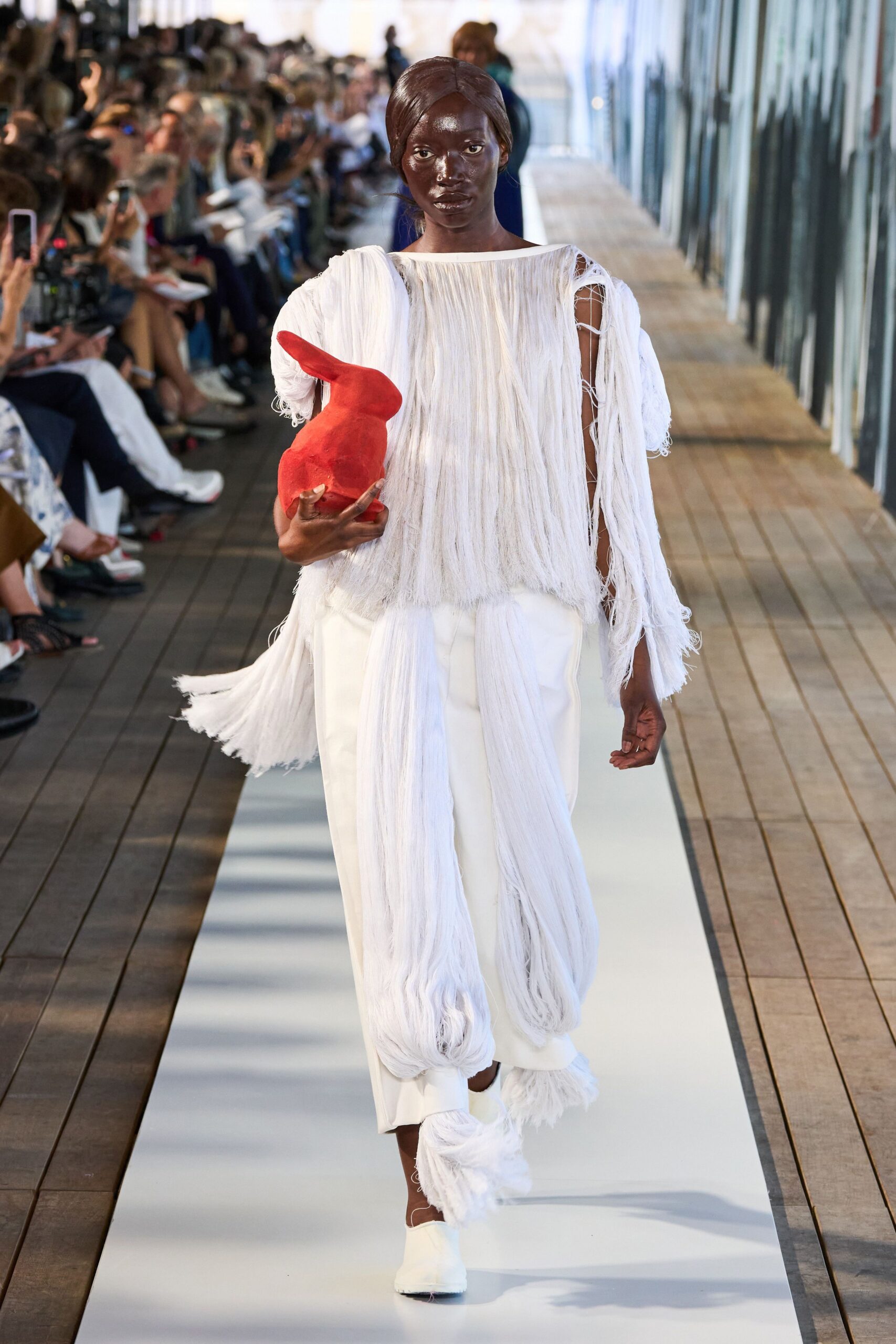 white fringed top with red bag