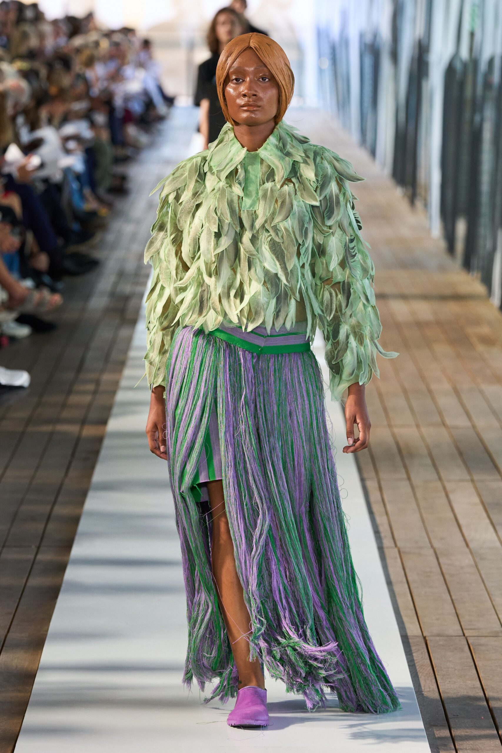 green fringed top with purple skirt