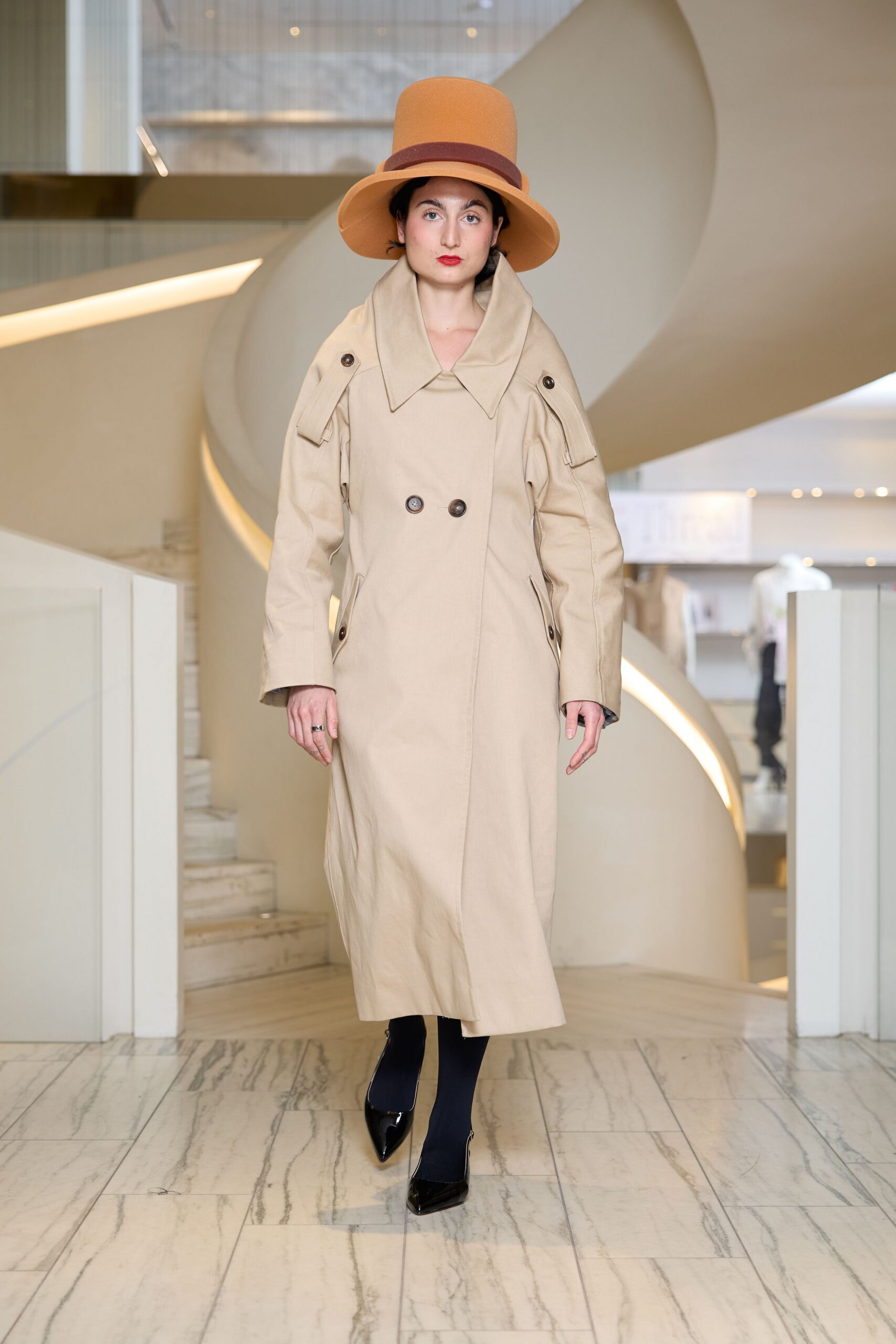 beige trench coat with orange hat