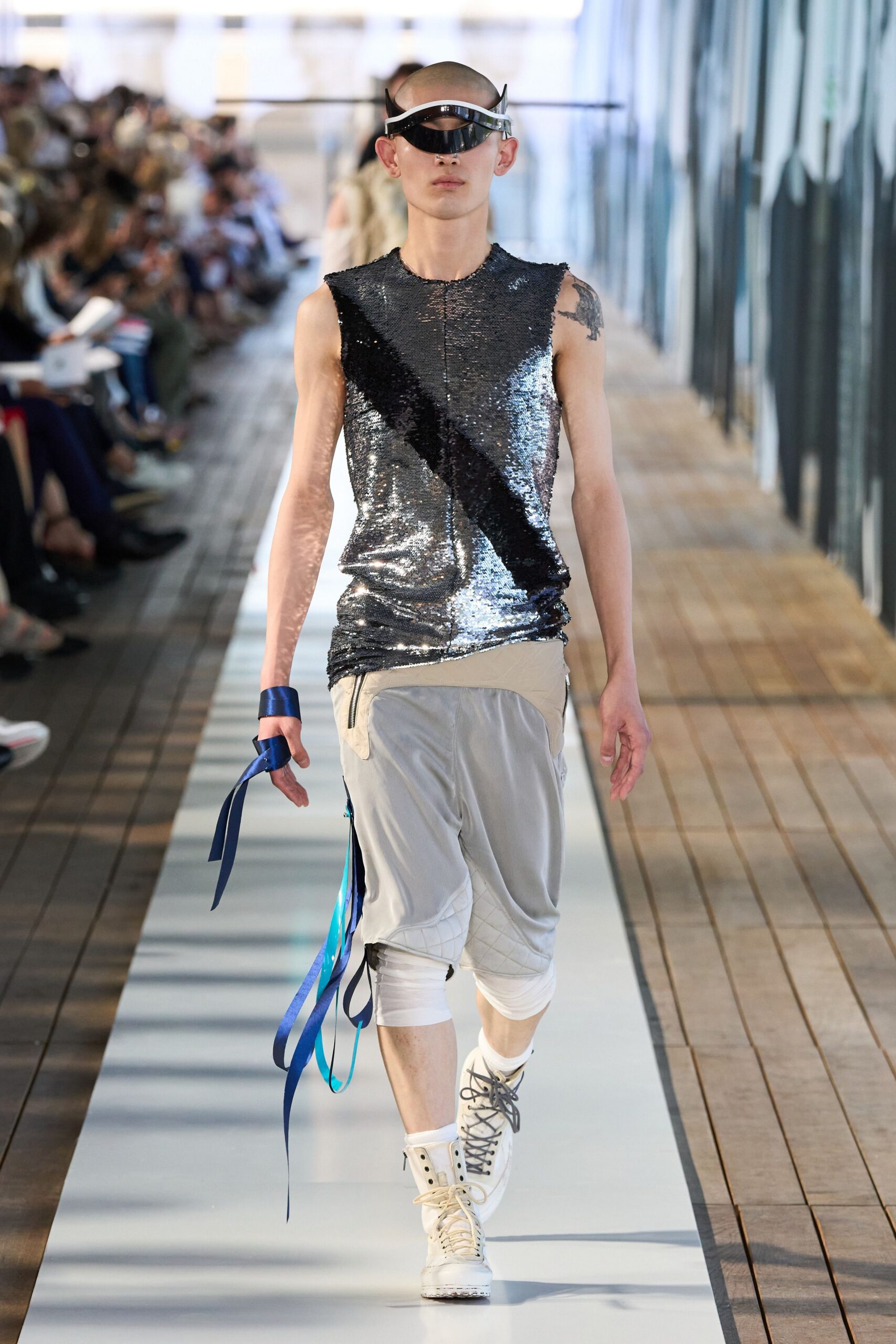 shiny silver sleeveless top with gray pants