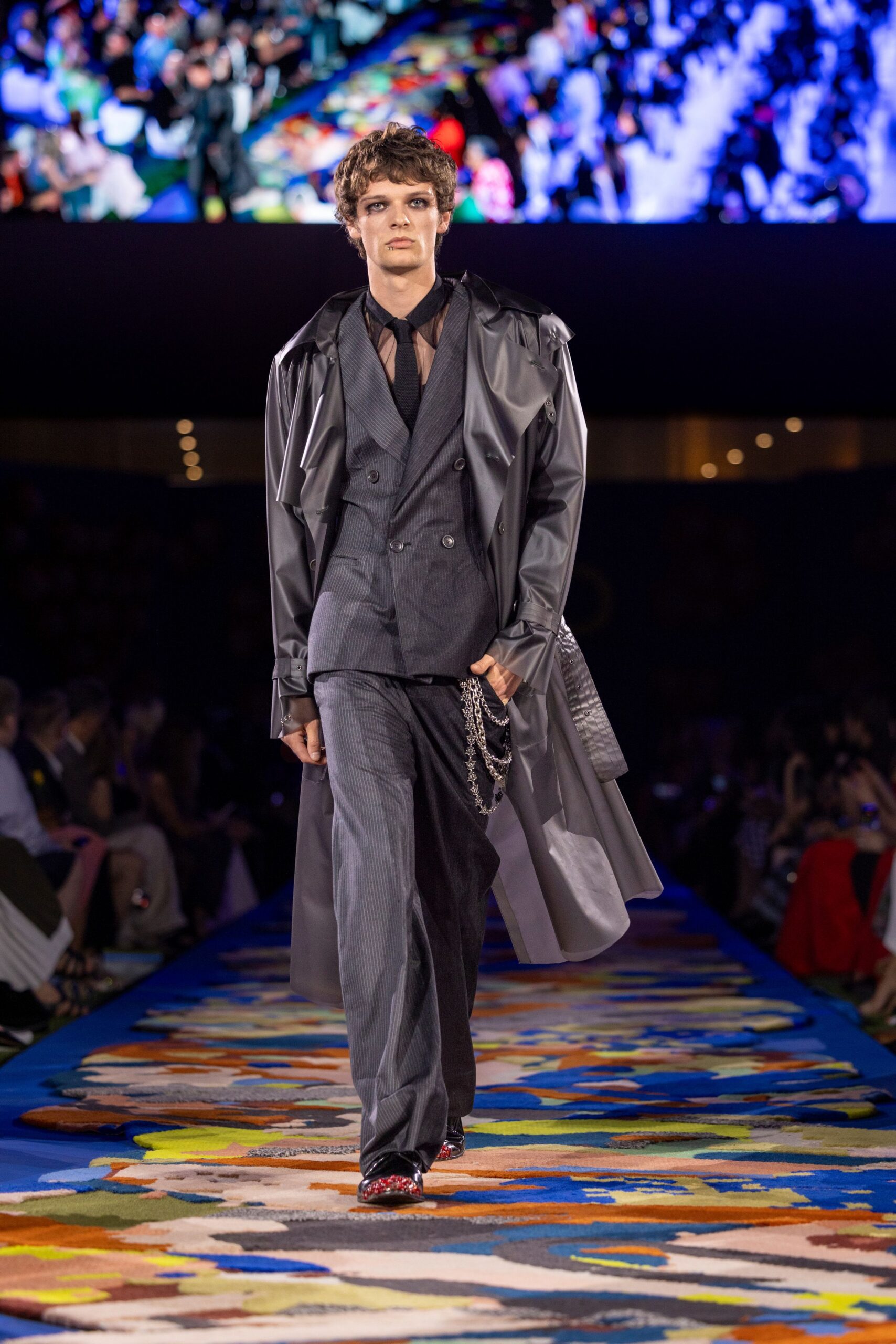 black vinyl trench coat with gray suit