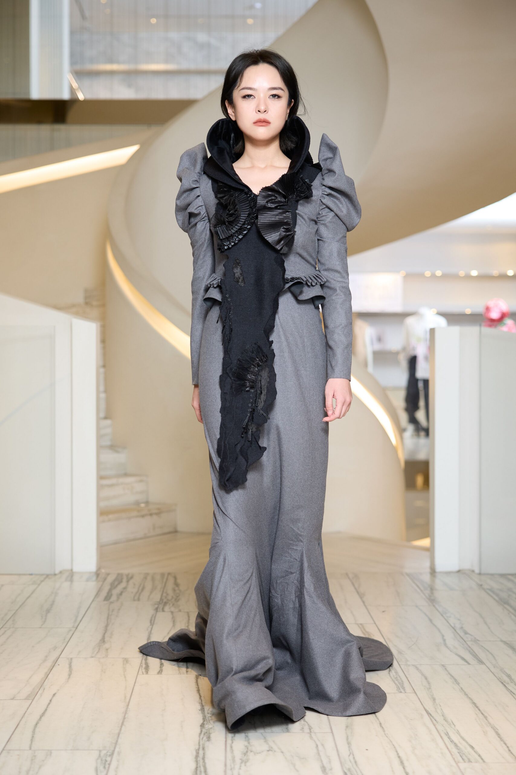 gray ruffled long-sleeve gown