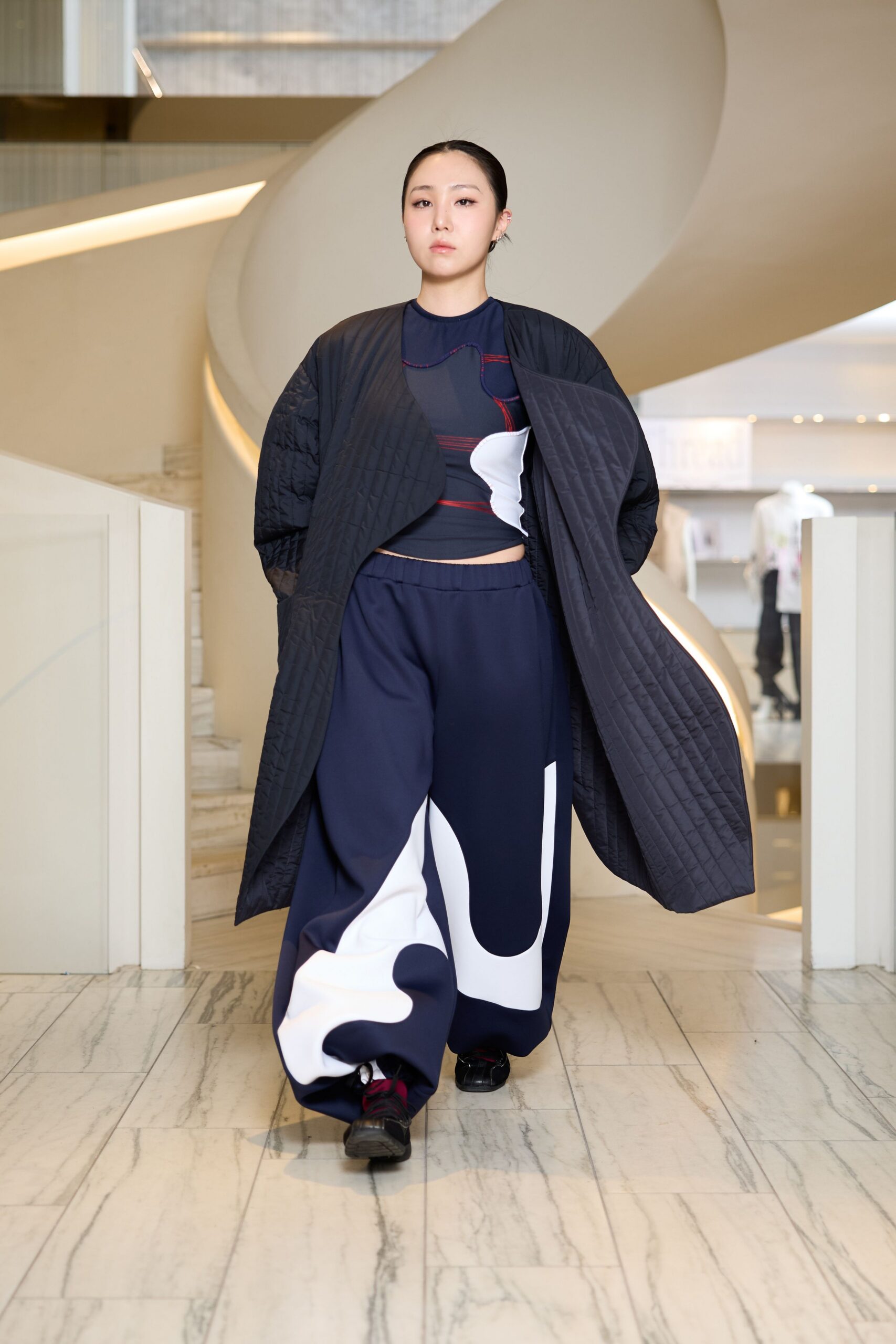 black coat with fitted top and wide-leg pants
