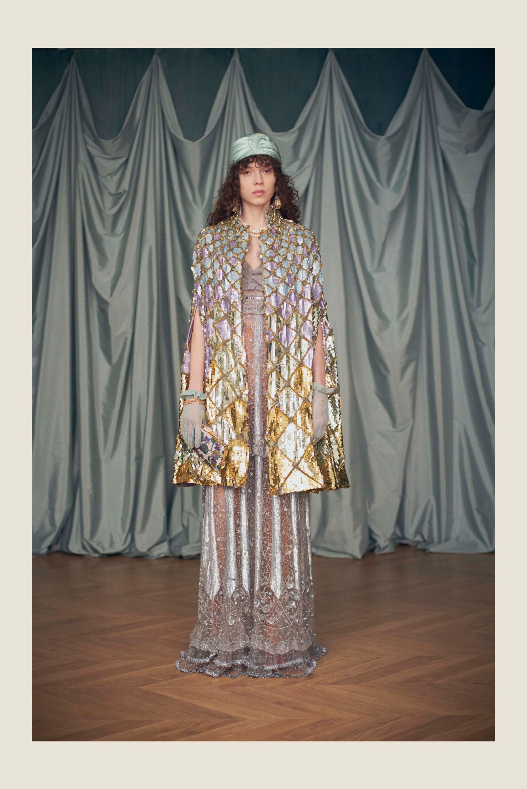 silver sequined gown with gold cape