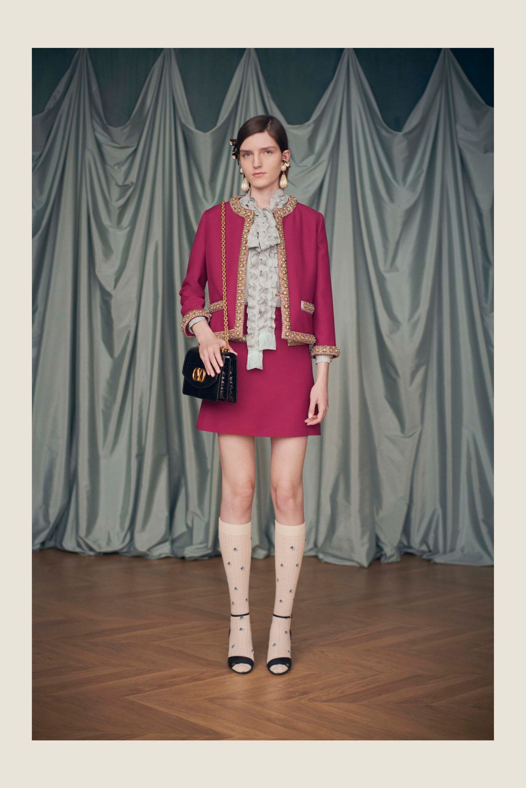 red blazer with white ruffled shirt