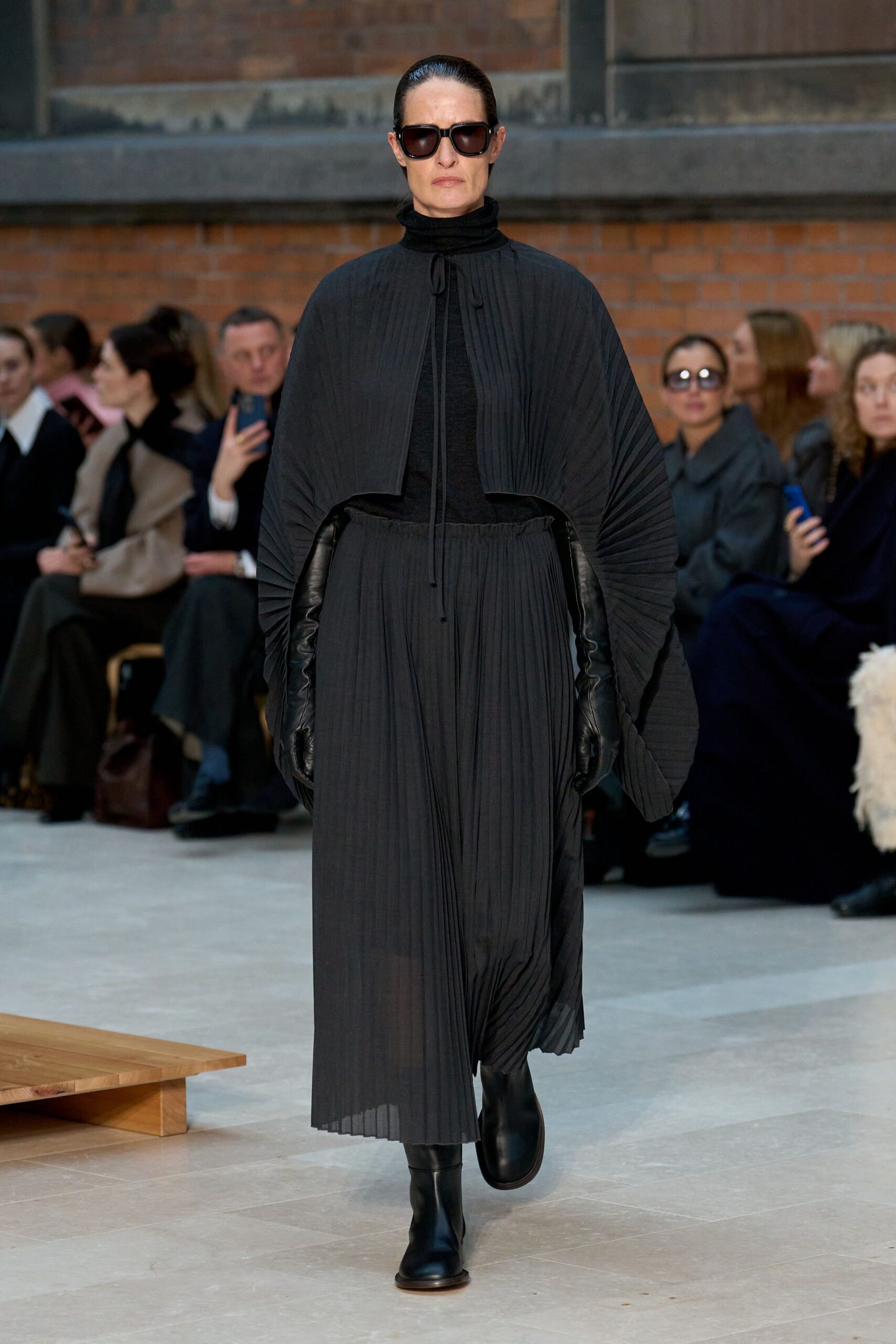 black pleated cape and skirt