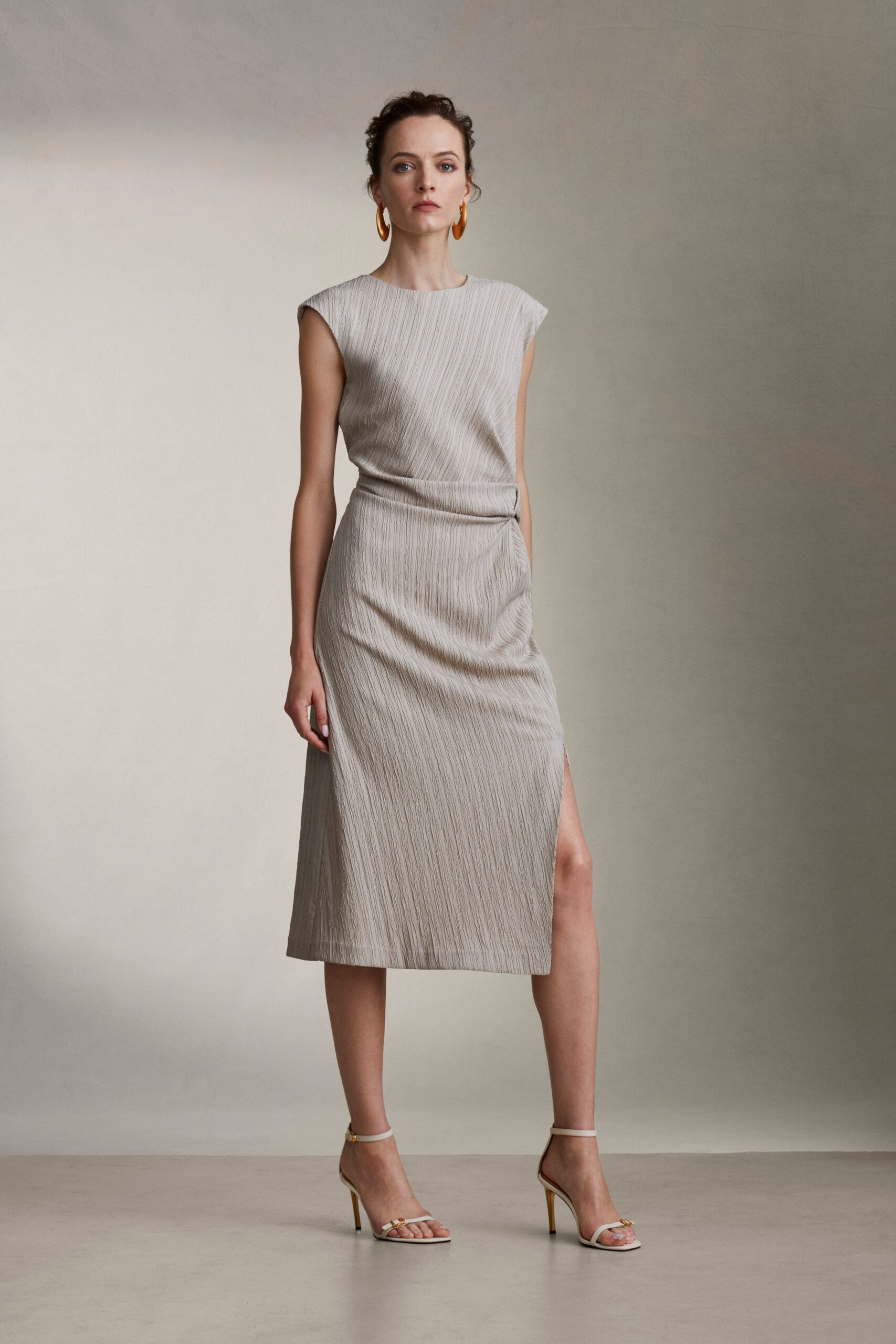 beige silk sleeveless high-neck fitted pleated midi dress