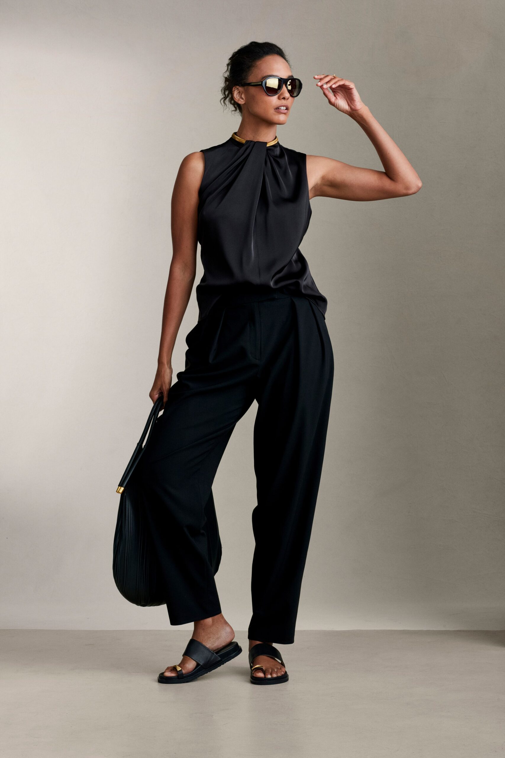 black silk sleeveless top with wide-leg pants