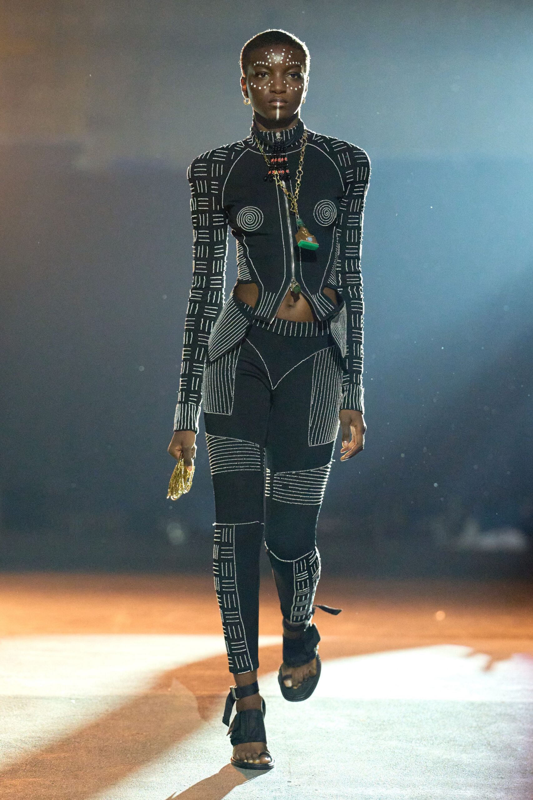 black fitted catsuit with strappy shoes