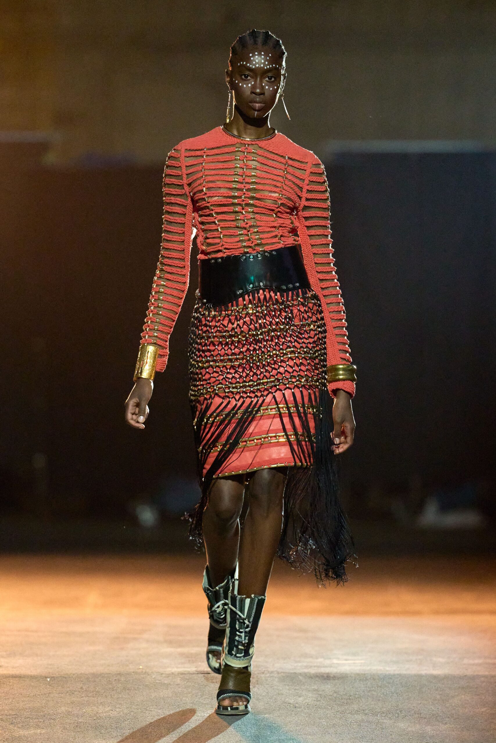 red fitted top black fringed skirt