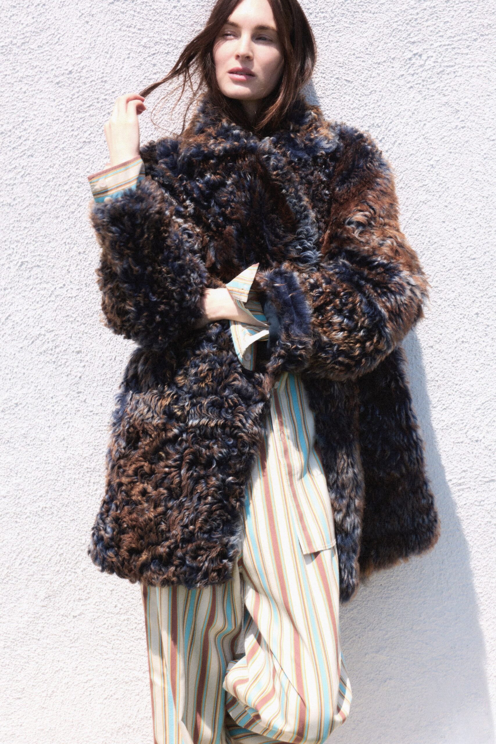 brown fur oversized coat and striped pants