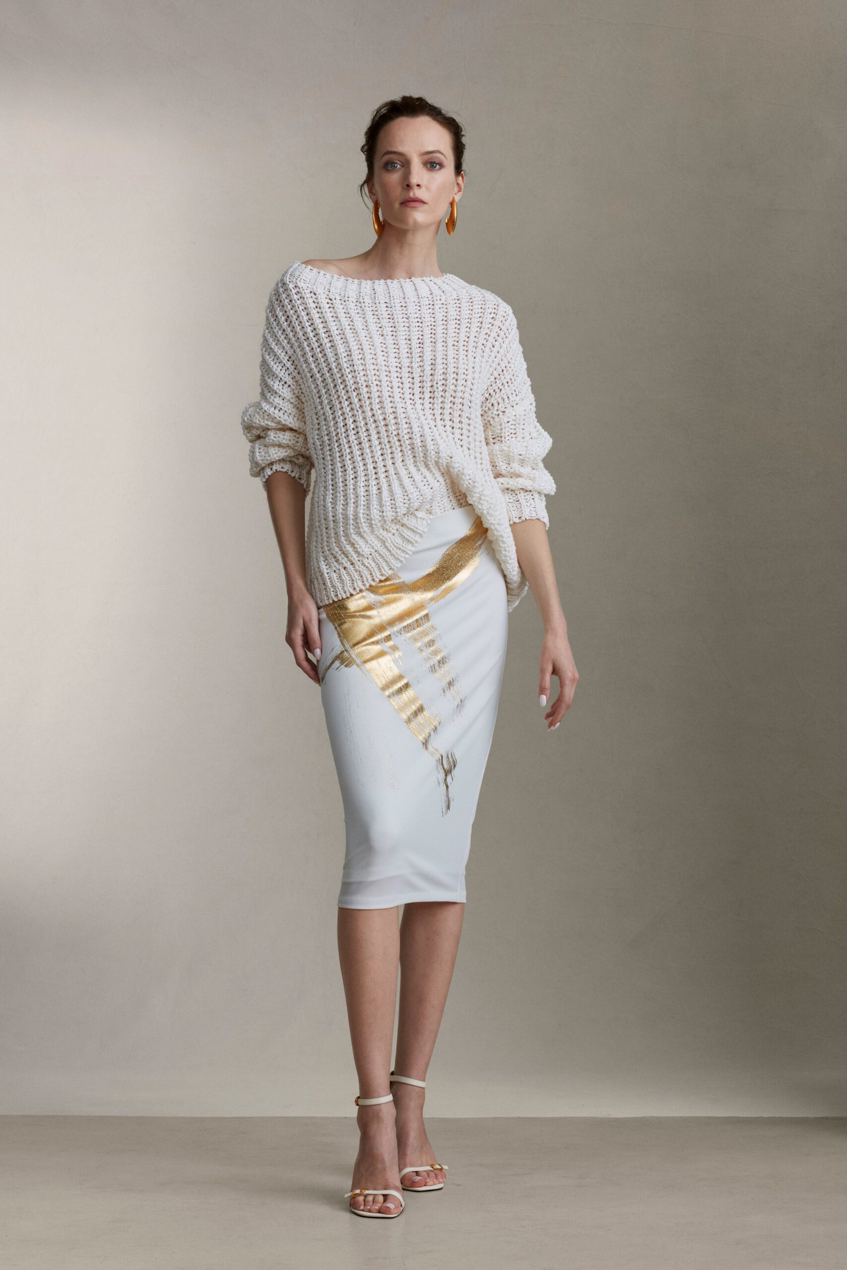 white knit sweater and gold skirt