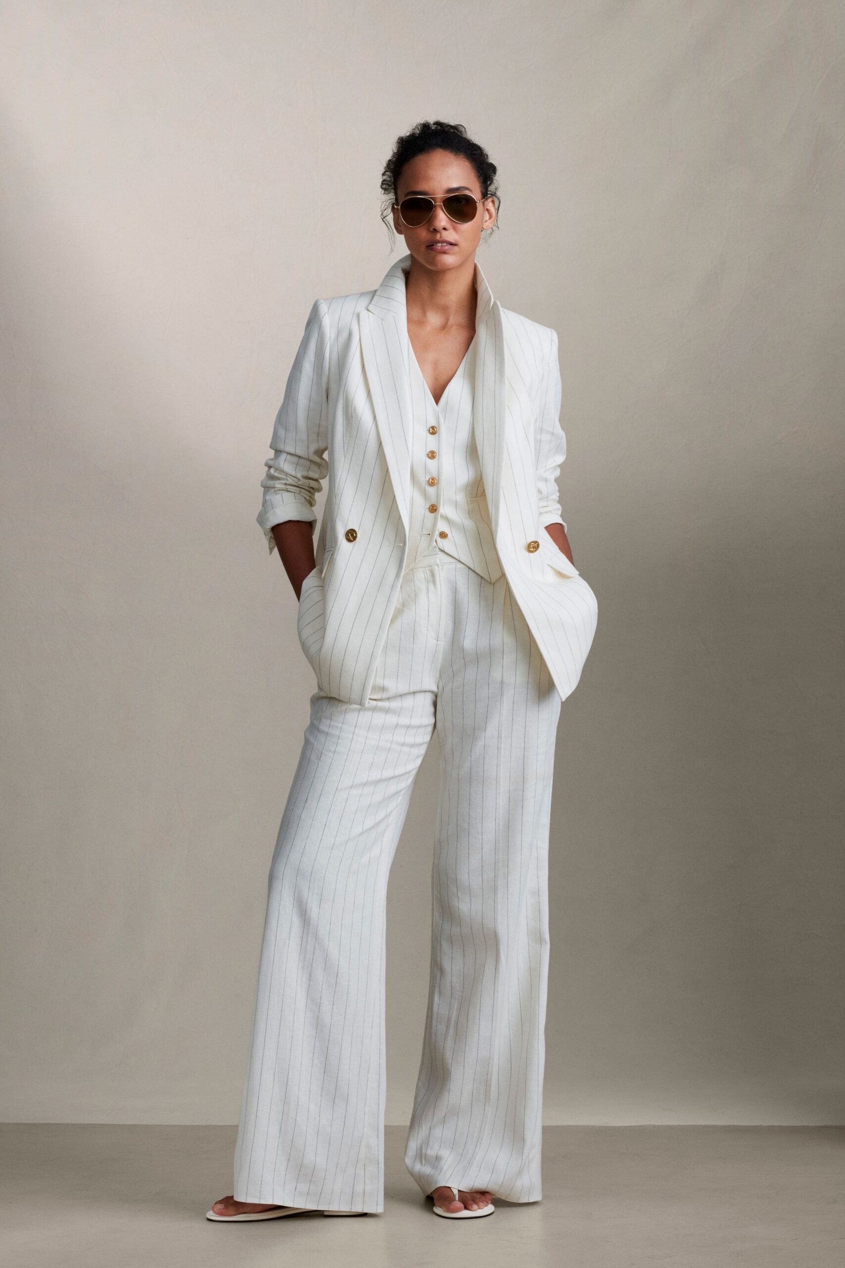white tailored suit with sunglasses