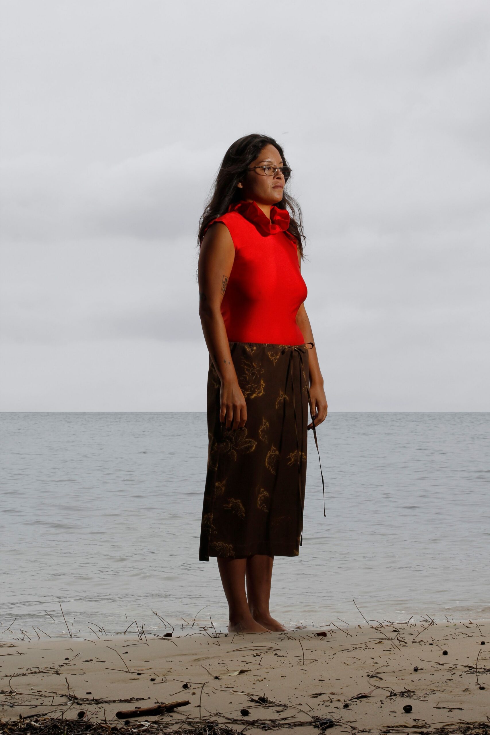 red sleeveless top and brown midi skirt