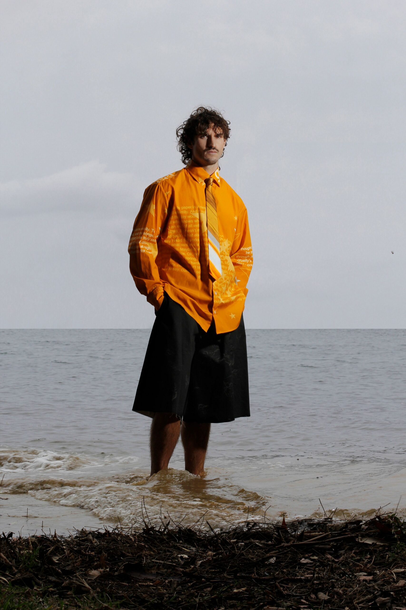 orange printed shirt and black shorts