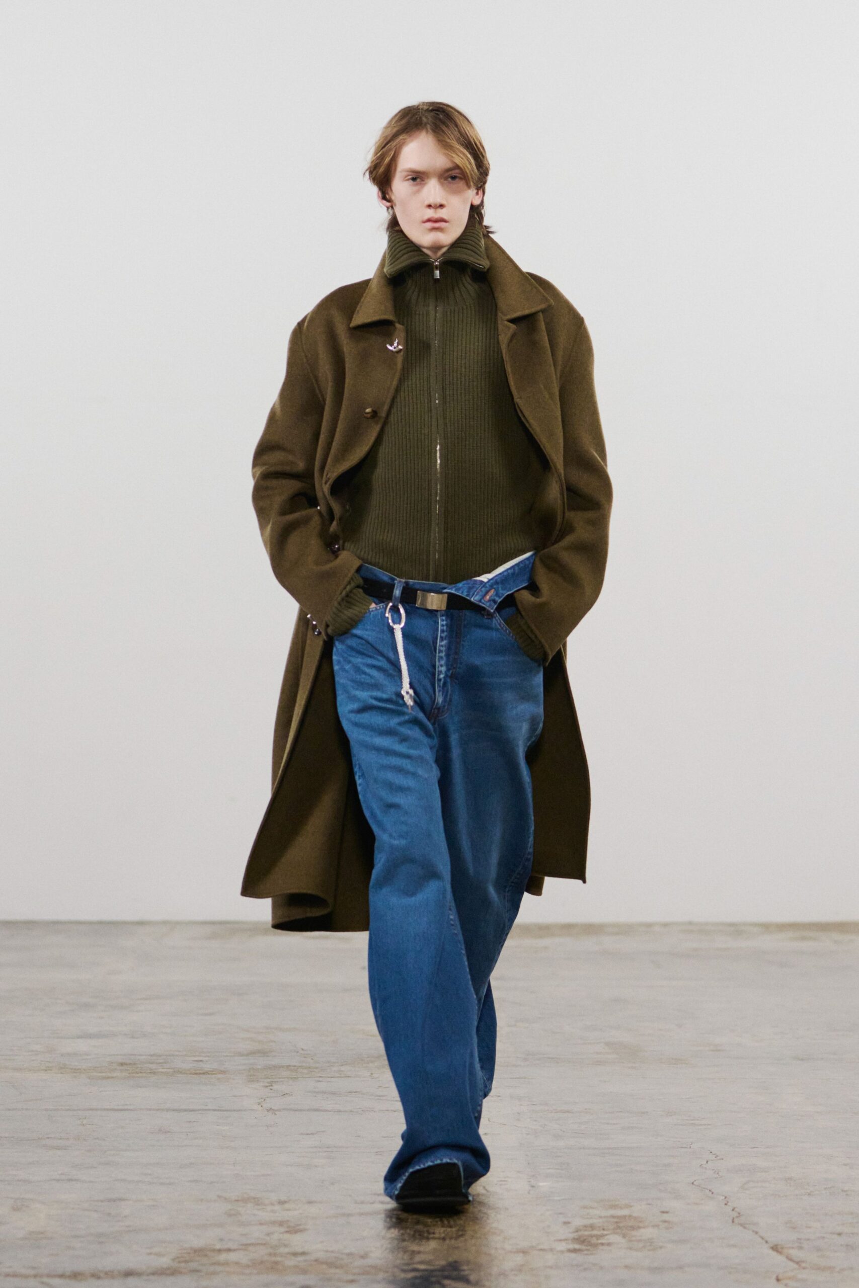 brown wool coat green top blue pants
