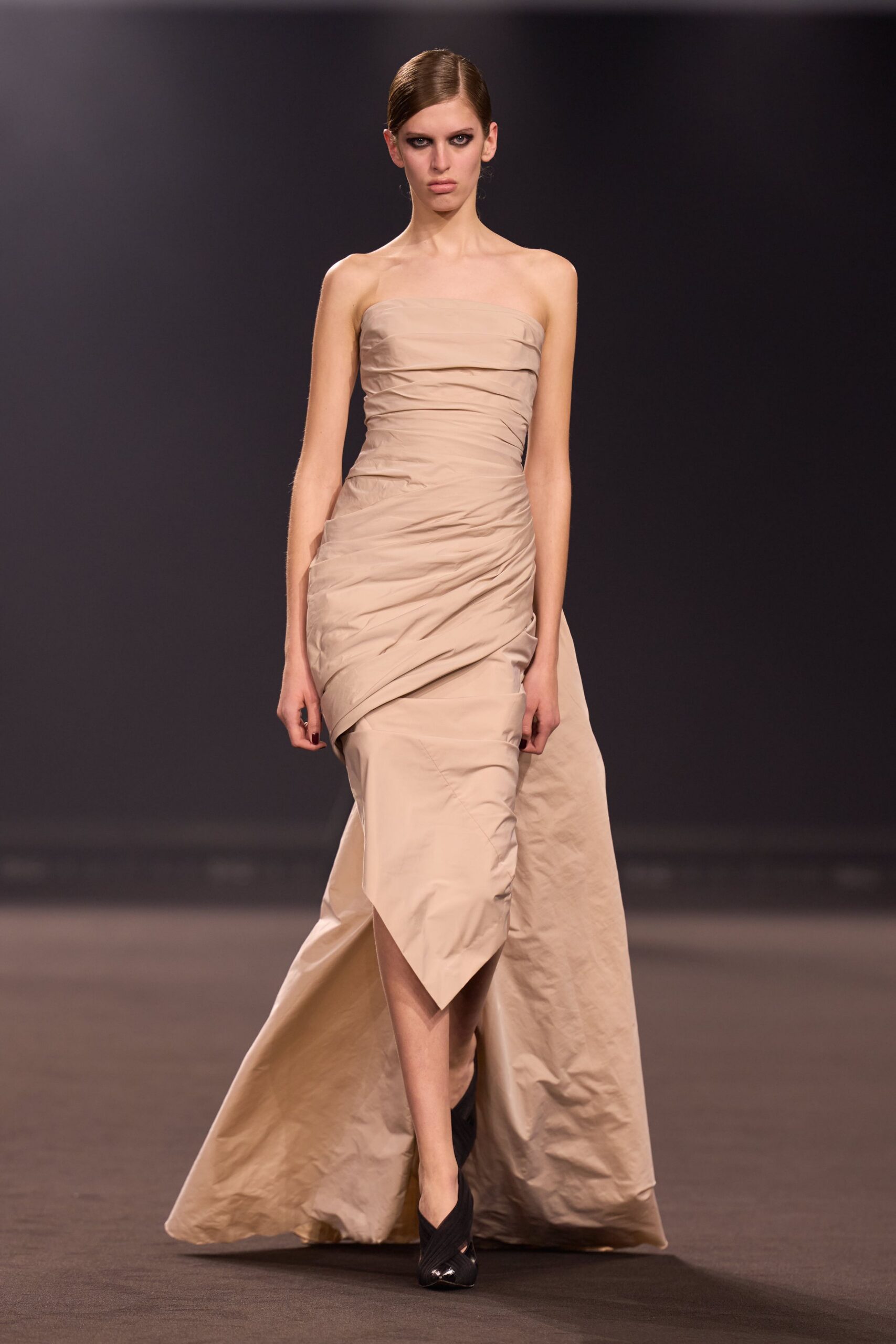 beige strapless draped gown with black heels