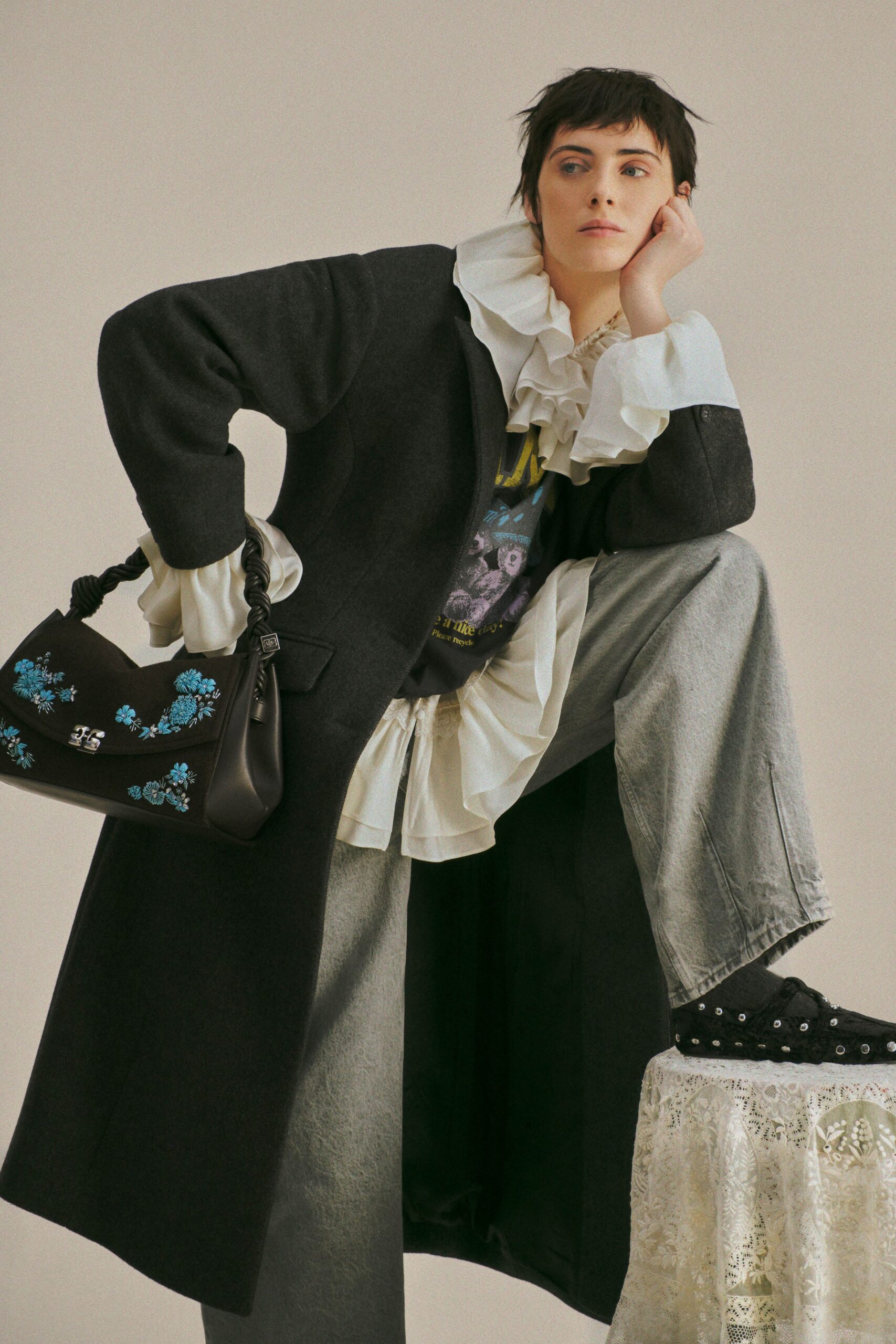 black wool coat with ruffled blouse