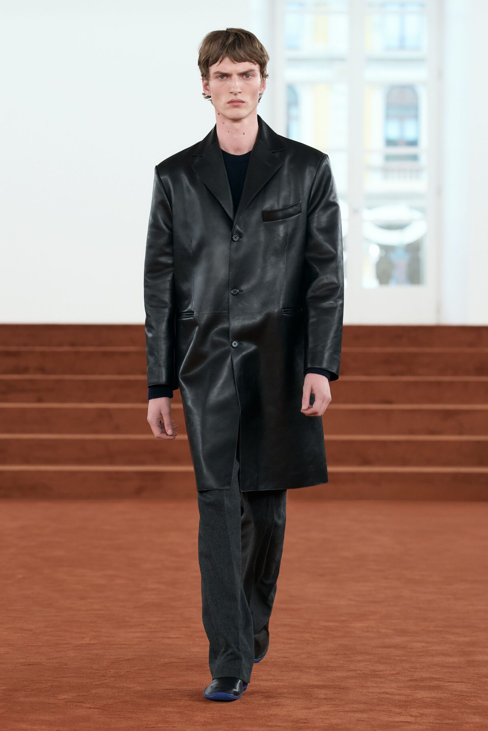 black leather long-sleeve collared structured buttoned coat