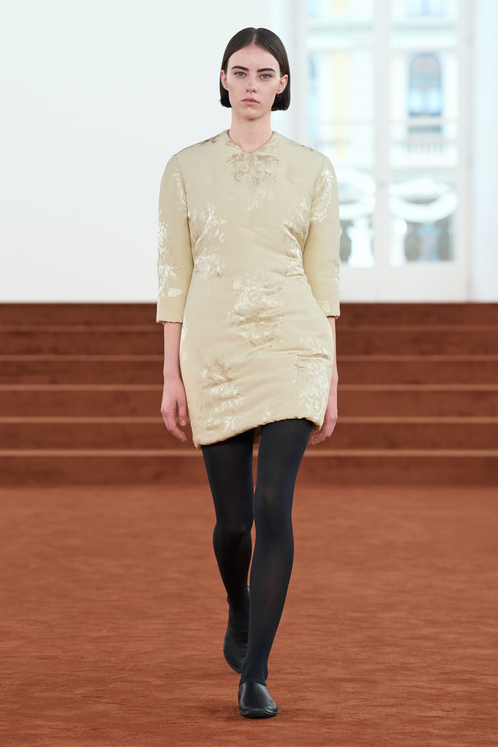 beige embroidered mini dress with black shoes