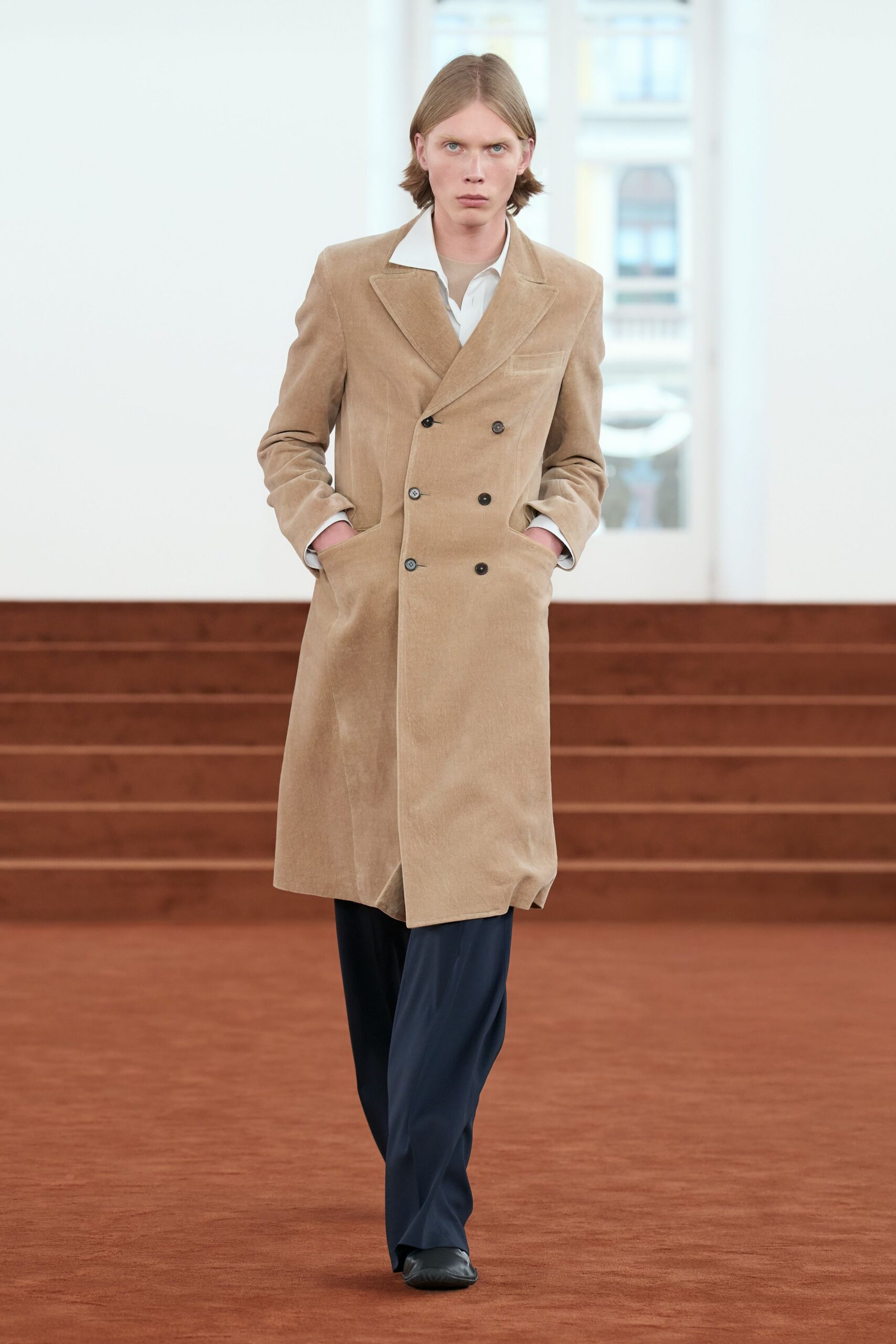 beige tailored coat with navy pants