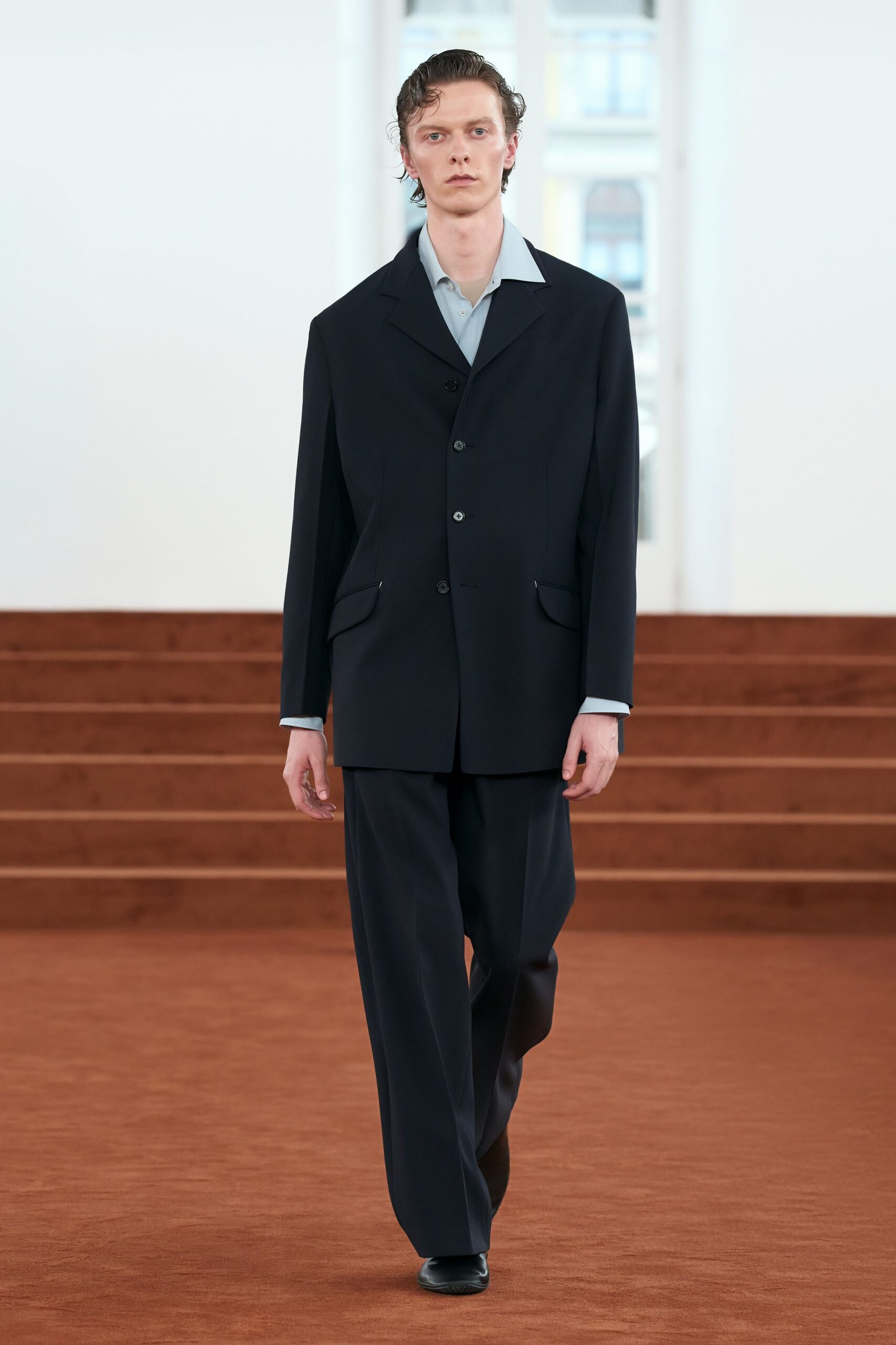 black tailored suit with light blue shirt