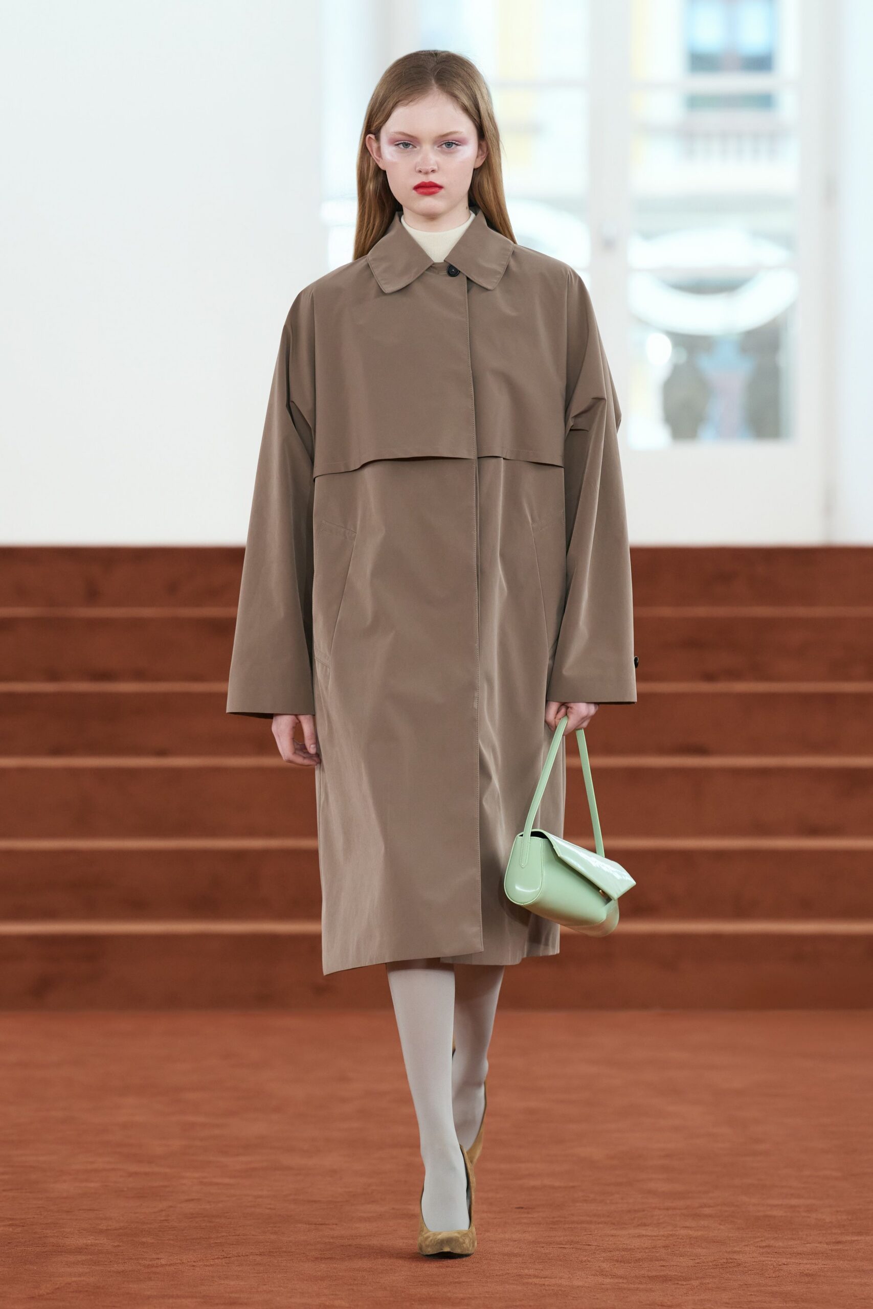 brown relaxed coat with green bag