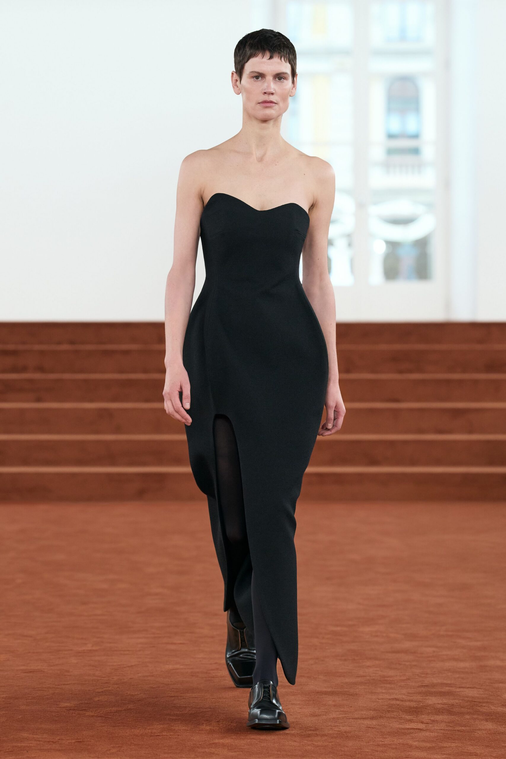 black fitted strapless gown with slit