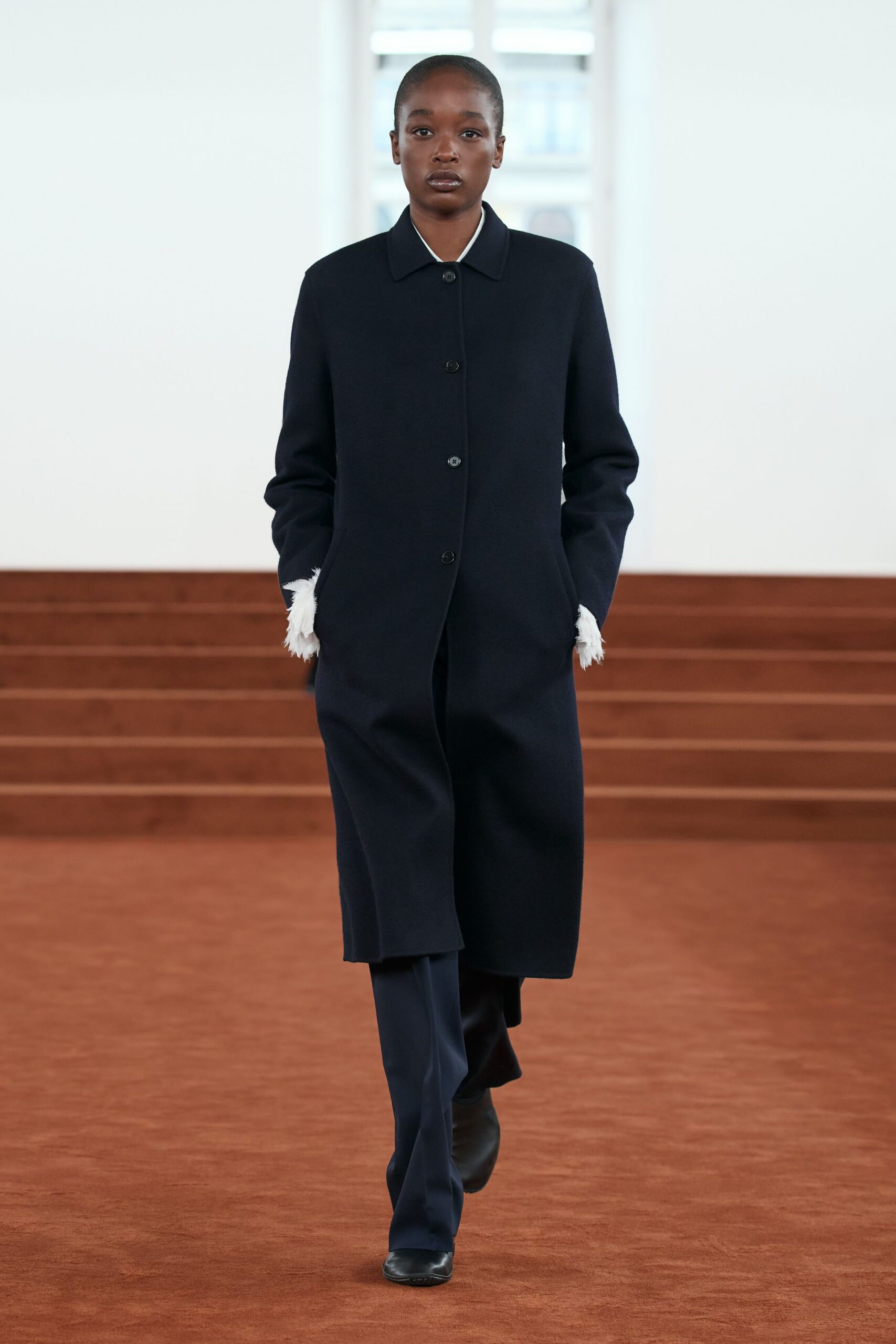 black wool coat and tailored pants
