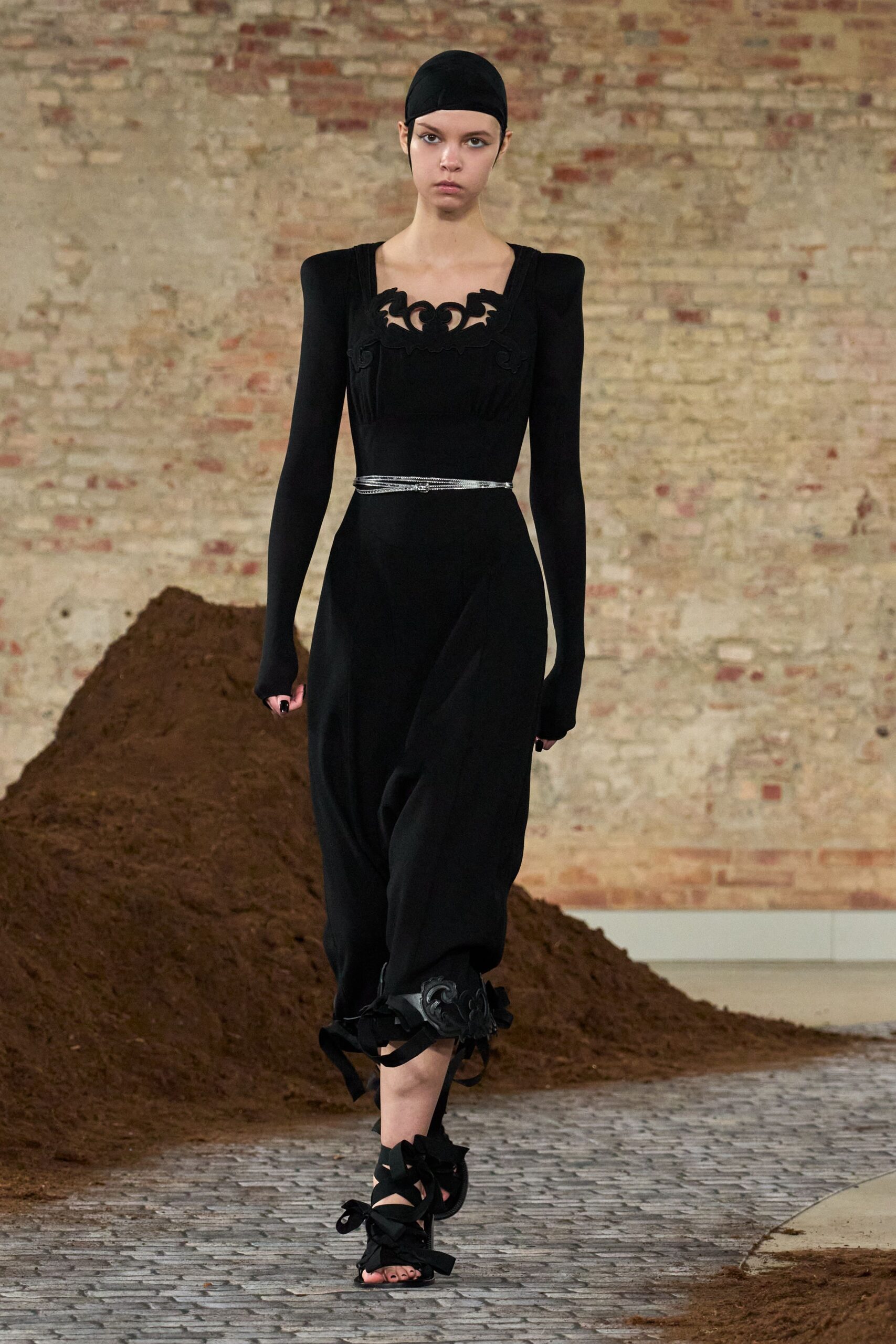 black fitted midi dress with strappy shoes