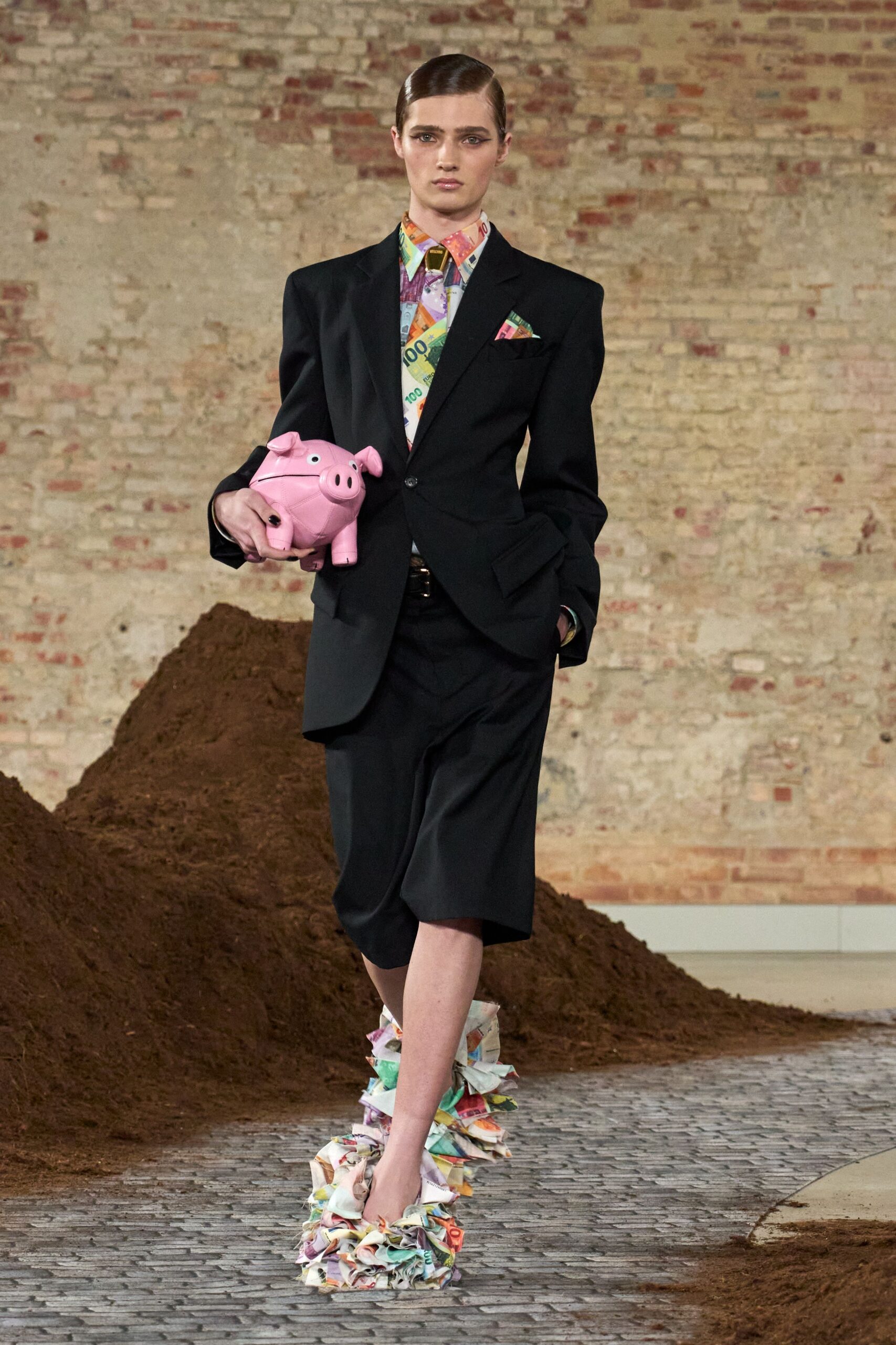black tailored suit with pink bag