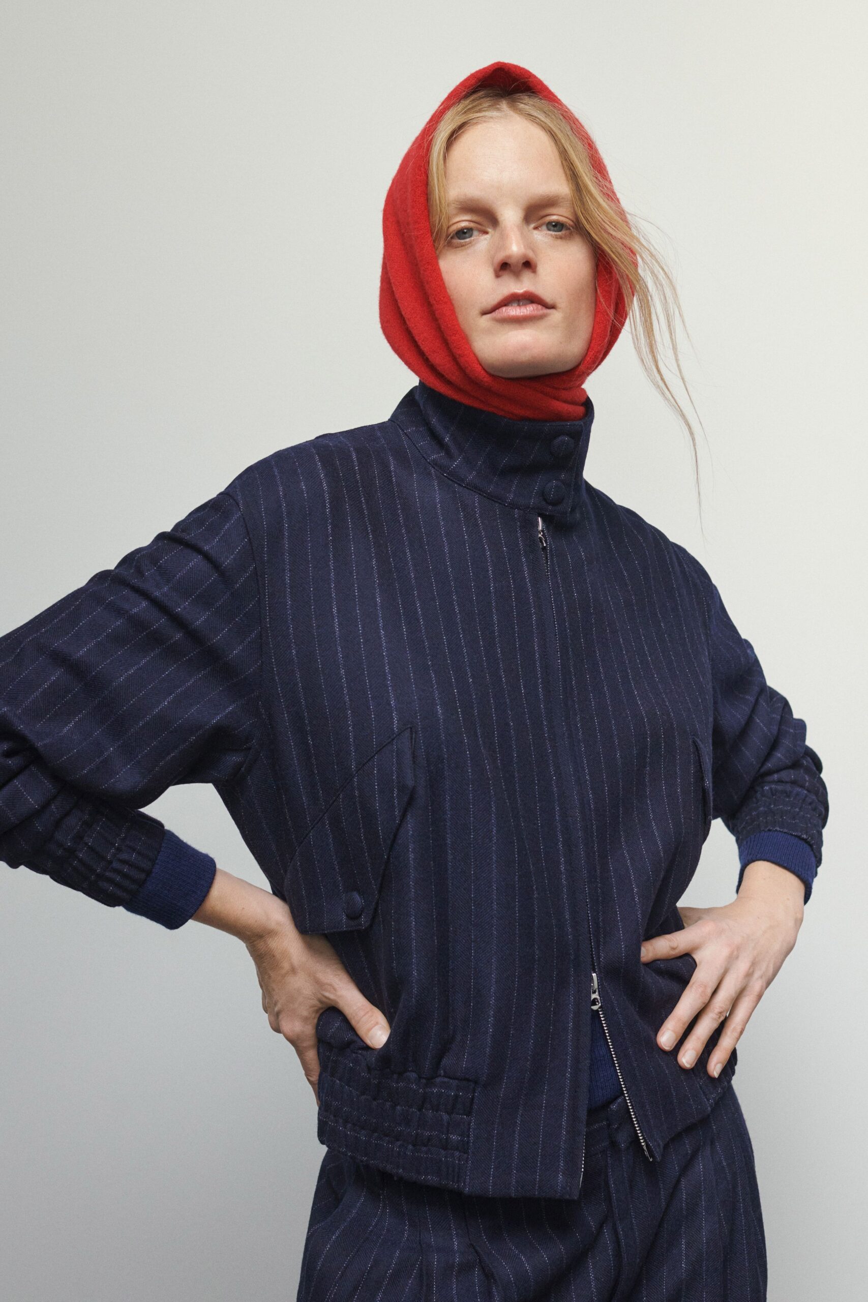 navy striped fitted jacket with red scarf