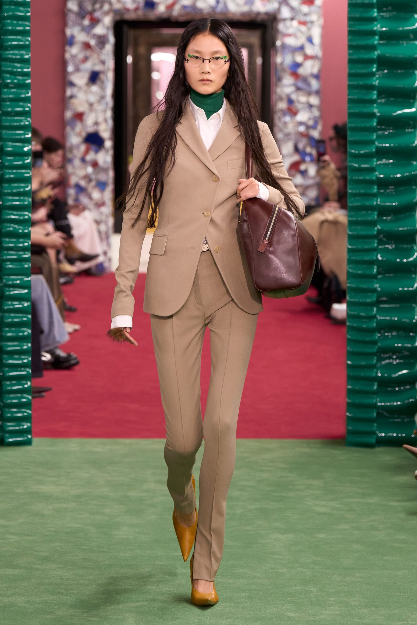 beige tailored suit with orange heels