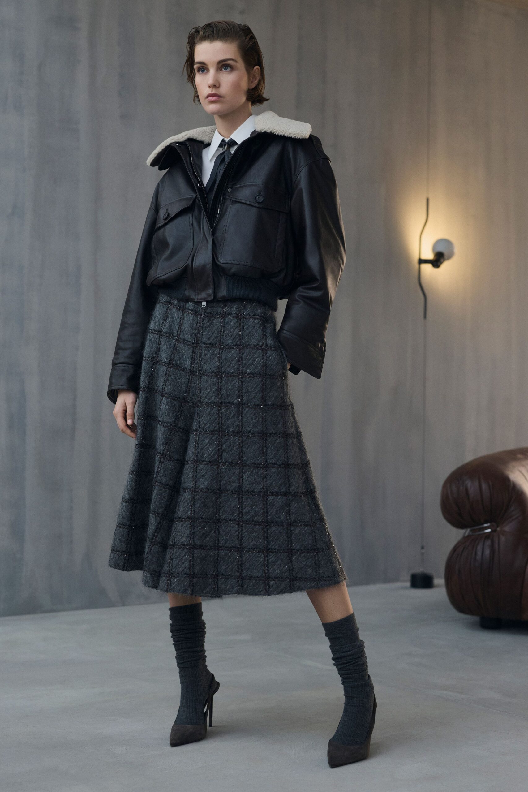 black leather jacket gray pleated skirt